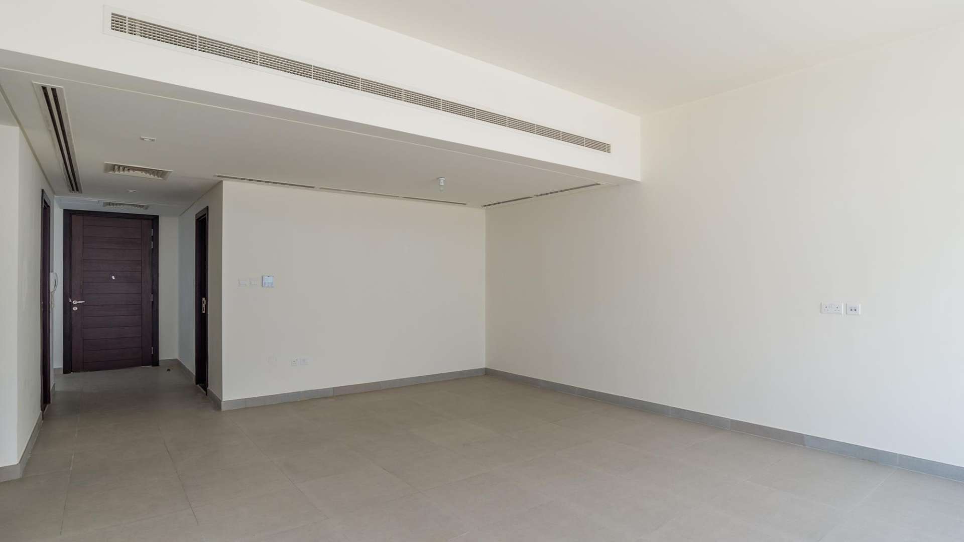 Interior view of empty living area in 3-bedroom townhouse, Arabella 1, Mudon, Dubai
