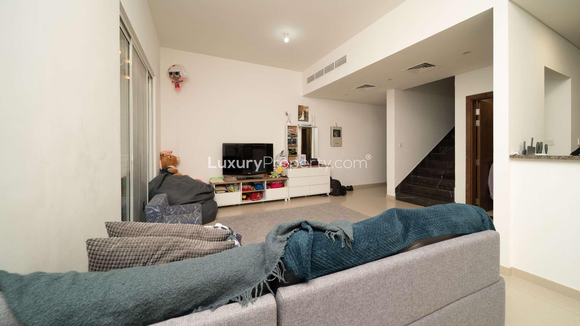 Modern 3-bedroom townhouse exterior in Arabella, Mudon, Dubai, featuring covered parking spaces