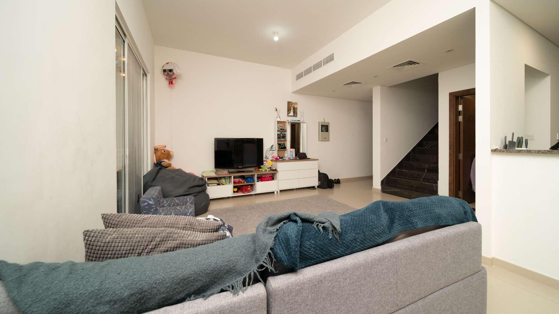 Modern 3-bedroom townhouse exterior in Arabella, Mudon, Dubai, featuring covered parking spaces