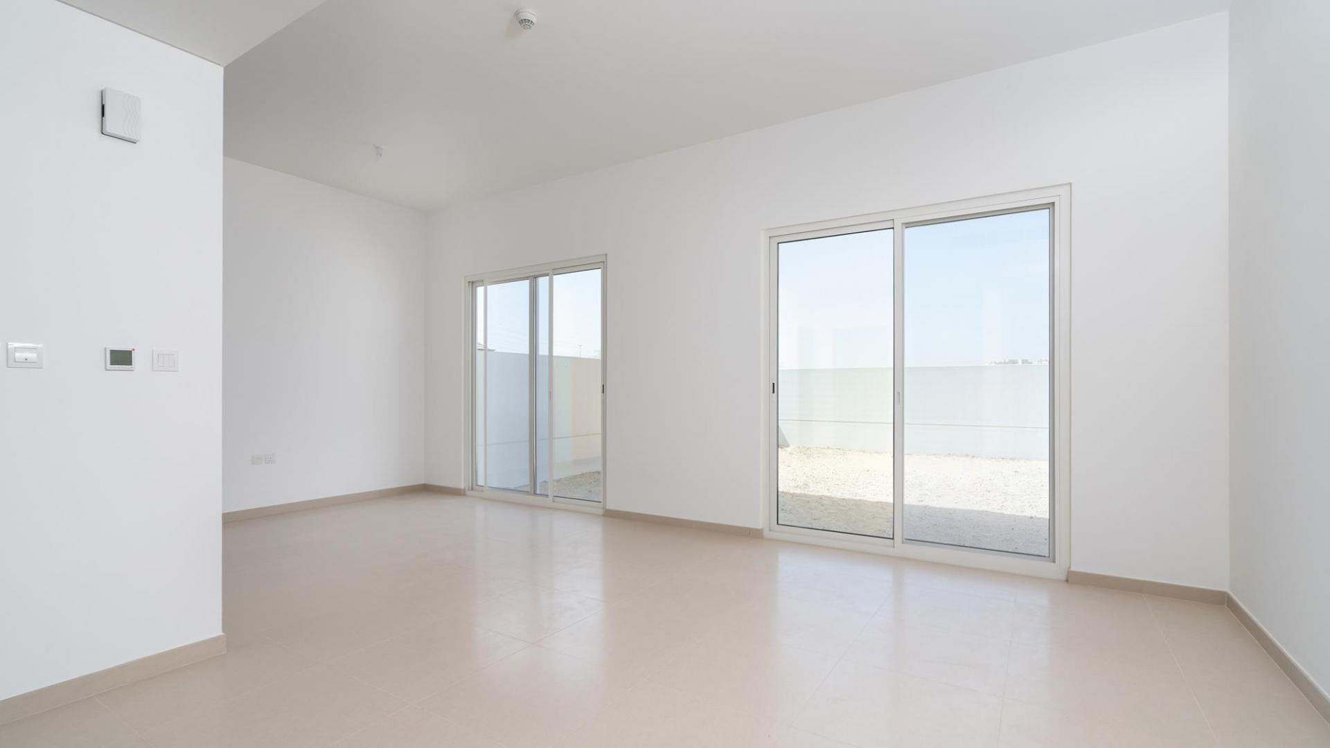 Spacious living room with large windows in Arabella townhouse, Mudon, Dubai