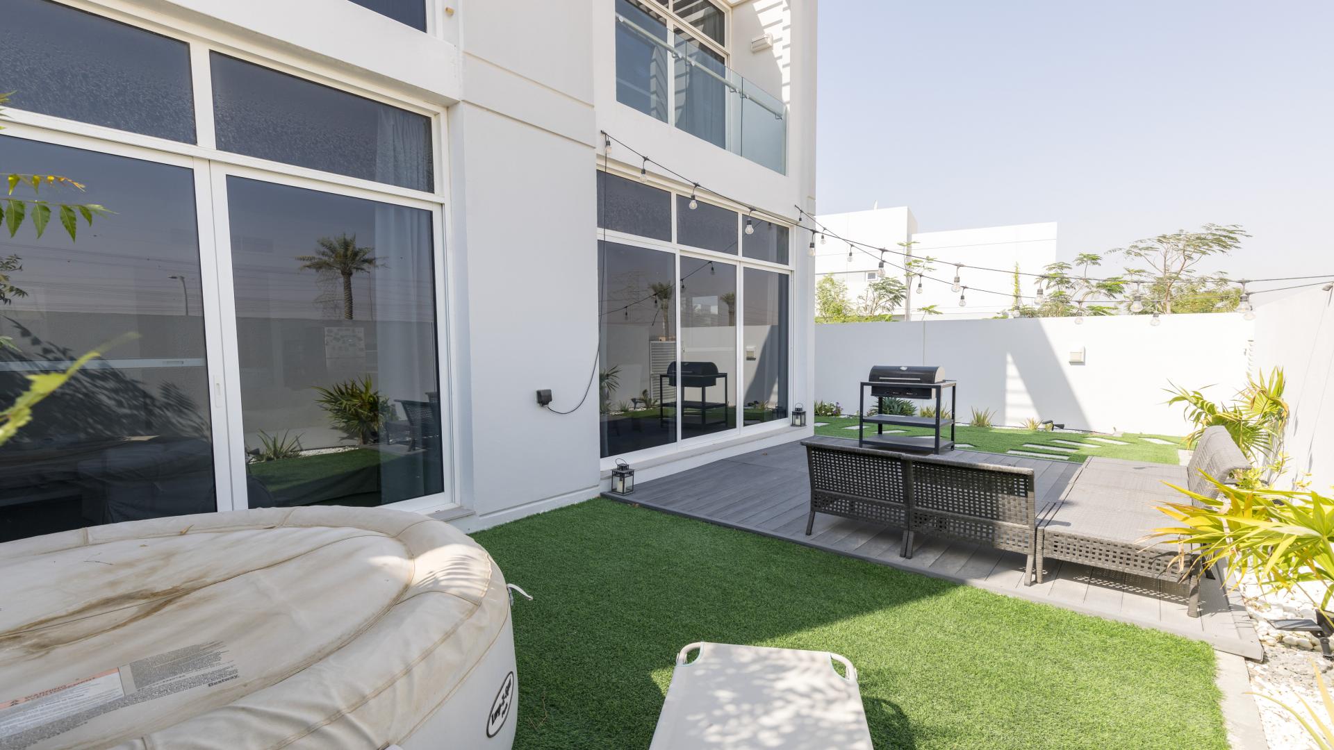 N/A,Outdoor patio of spacious 3-bedroom townhouse in Arabella, Mudon with seating and grill