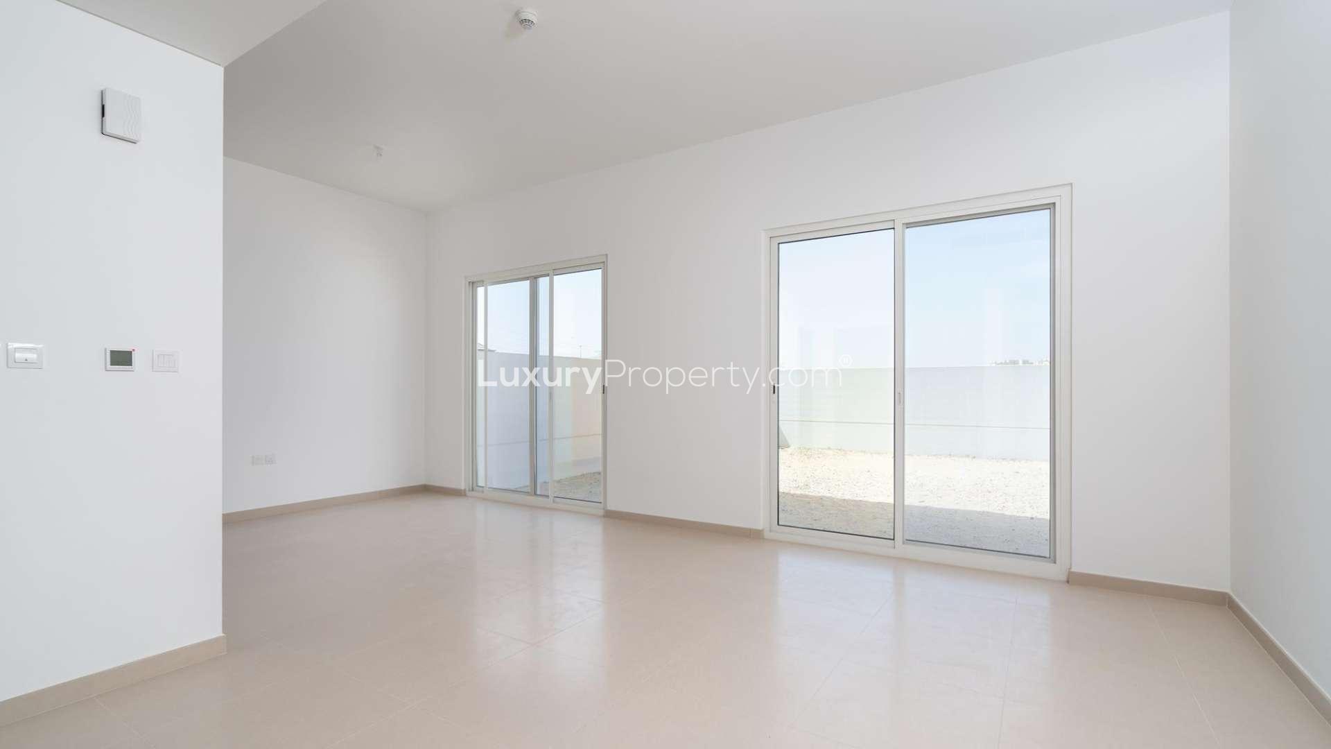 Empty living area in Arabella townhouse, Mudon community, with modern open-plan design