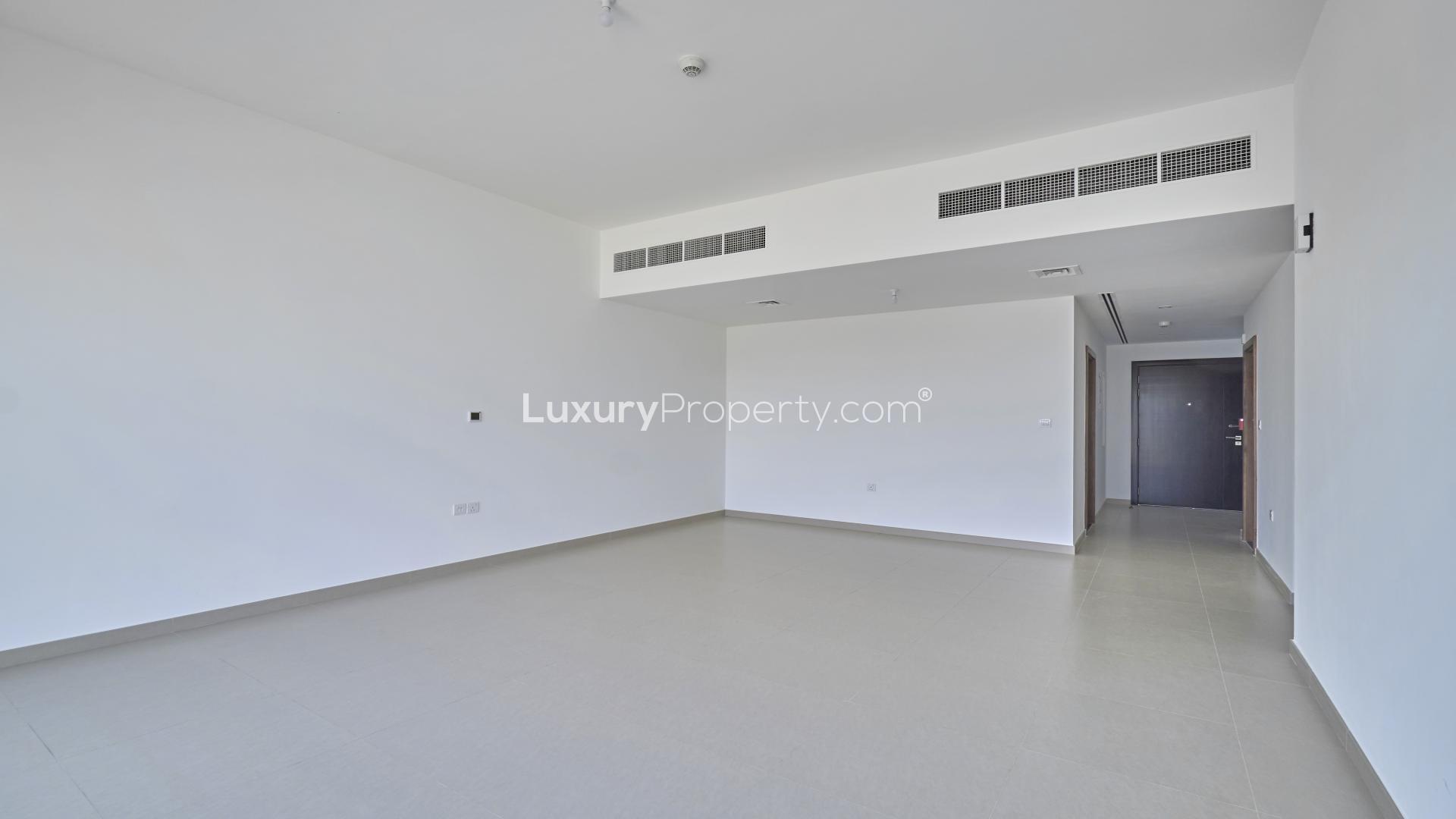 Spacious living room with large windows in 3-bedroom villa, Arabella Townhouses, Mudon