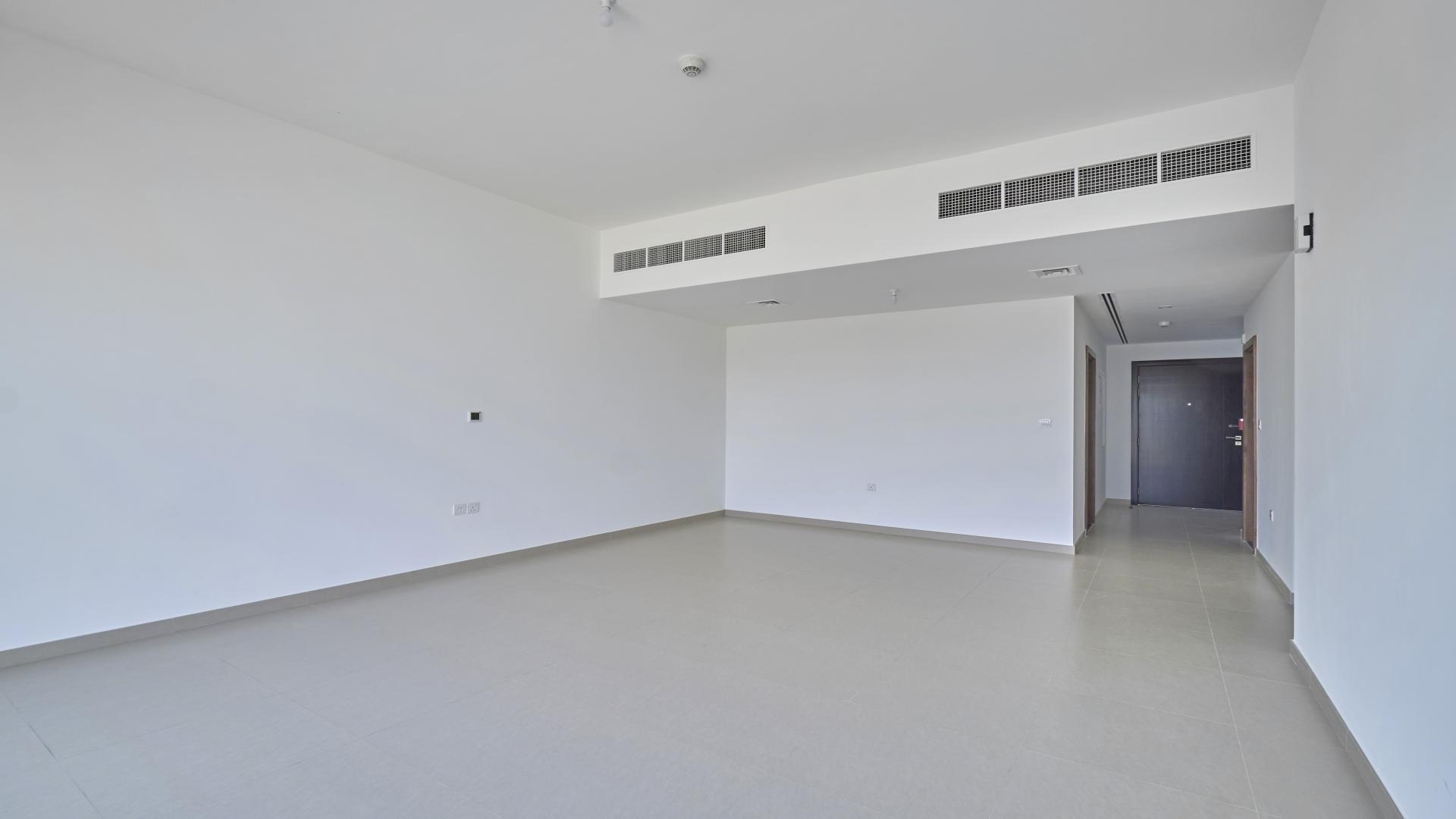 Spacious living room with large windows in 3-bedroom villa, Arabella Townhouses, Mudon