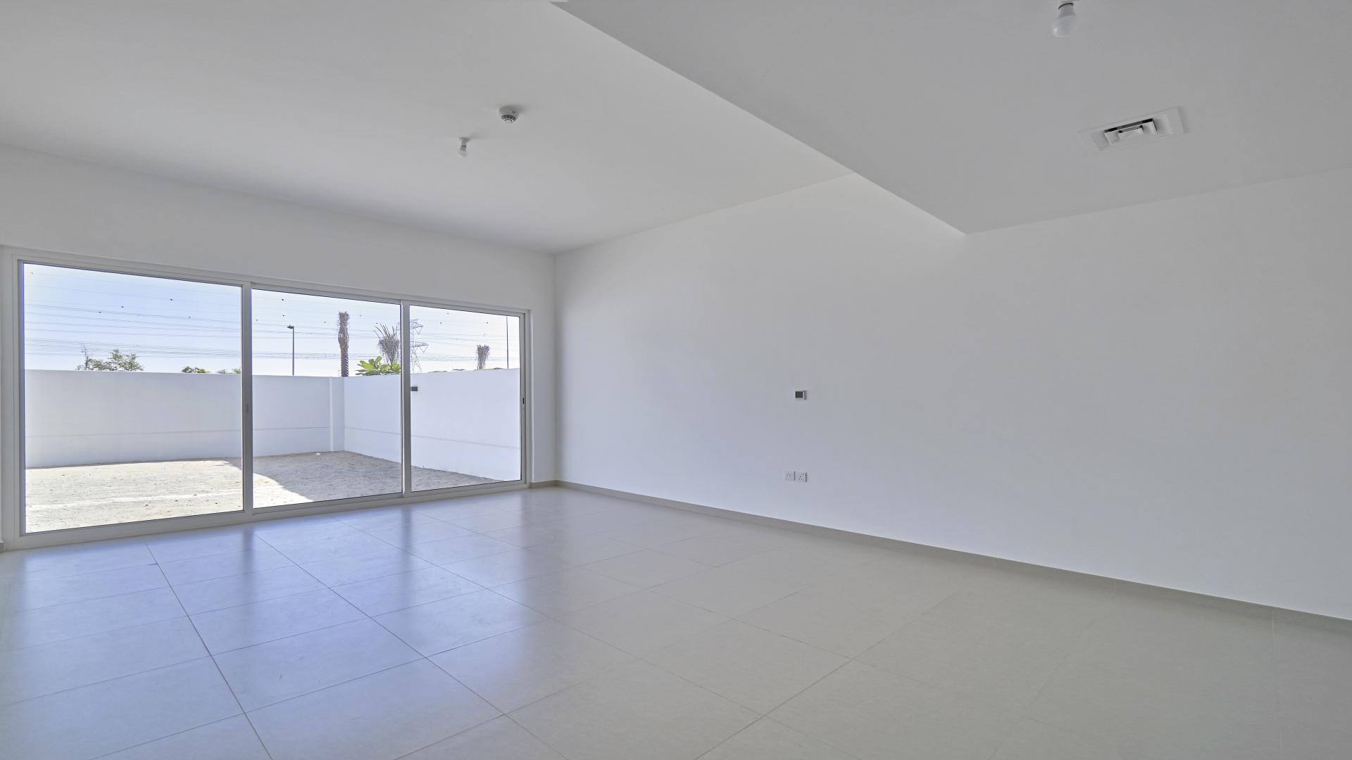 Bright living room with large windows in Arabella 3-bedroom villa, Mudon for sale