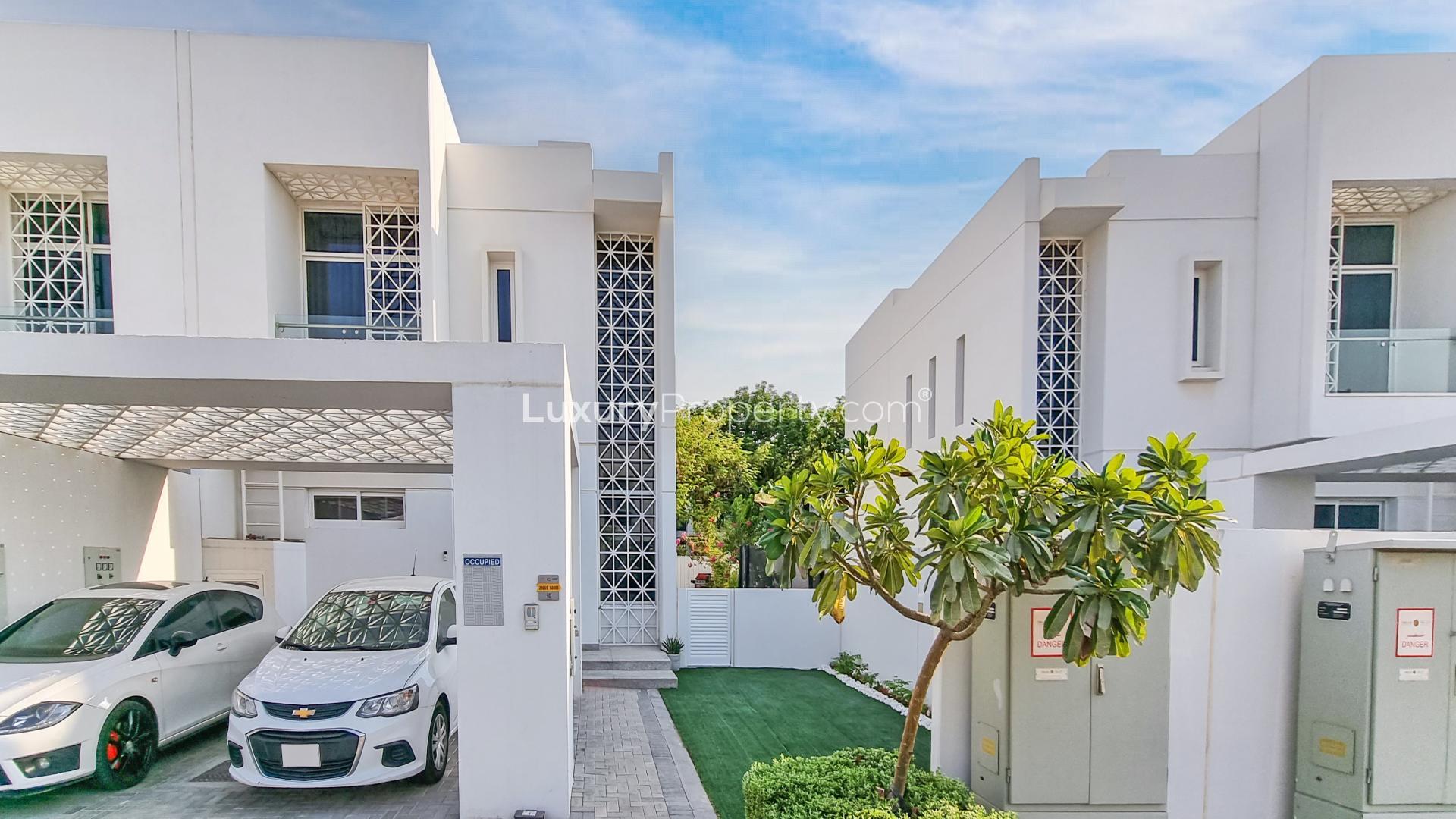 Modern townhouses in Arabella, Mudon community, featuring sleek design and landscaped surroundings