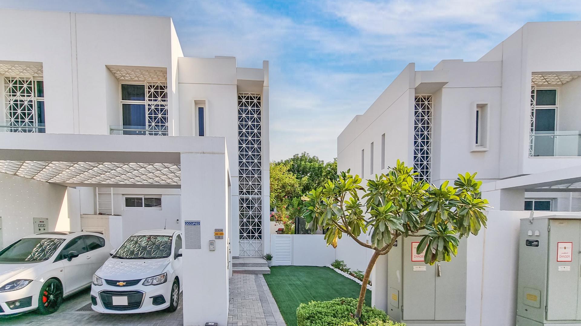 Modern townhouses in Arabella, Mudon community, featuring sleek design and landscaped surroundings