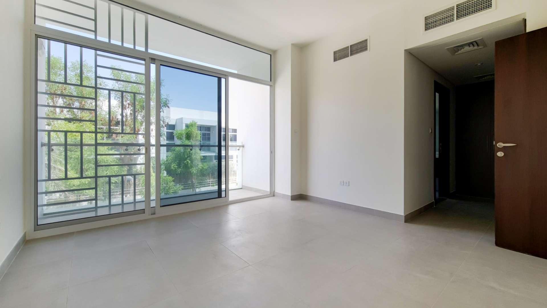 Open-plan living area in Mudon Arabella Townhouse, featuring modern kitchen and spacious layout