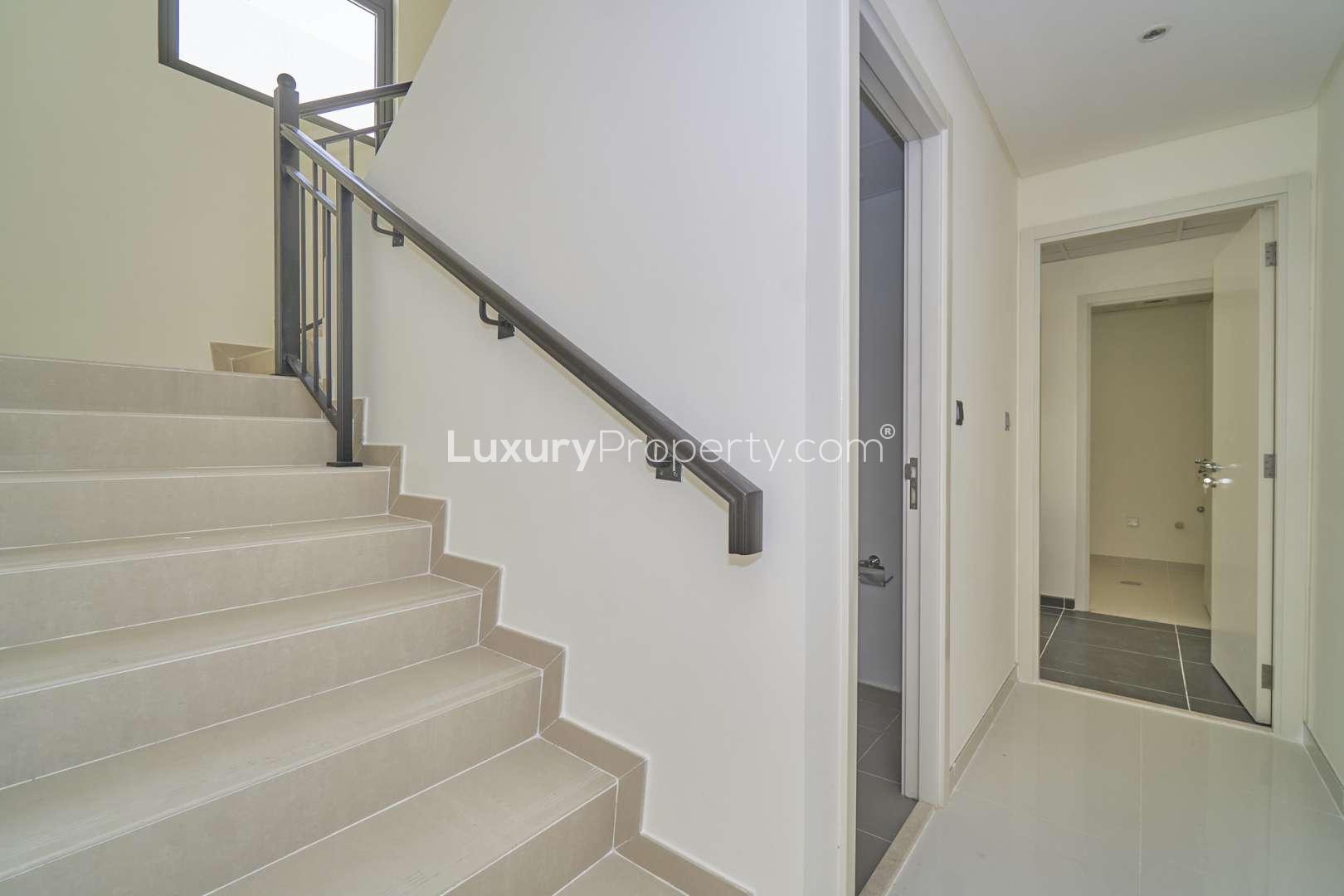 Stylish townhouse exterior in Aster, Damac Hills 2, with modern design and covered parking
