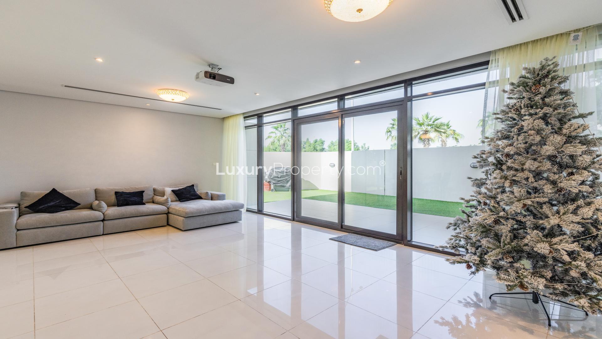 Spacious townhouse exterior in Brookfield, Damac Hills with modern design and two-car driveway