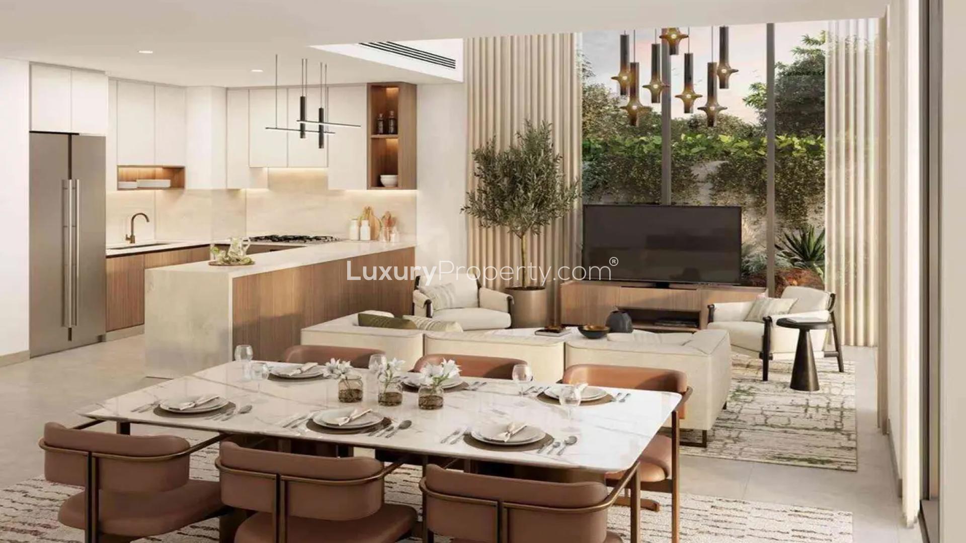 "Elegant living room with garden view in Mudon Al Ranim townhouse, Dubai for sale.",Modern kitchen and dining area in Mudon Al Ranim townhouse, Dubai, for sale