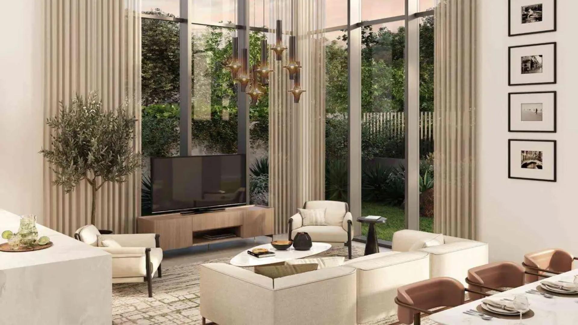 Modern townhouse exterior with garden in Mudon Al Ranim, Dubai, featuring carport and pathway