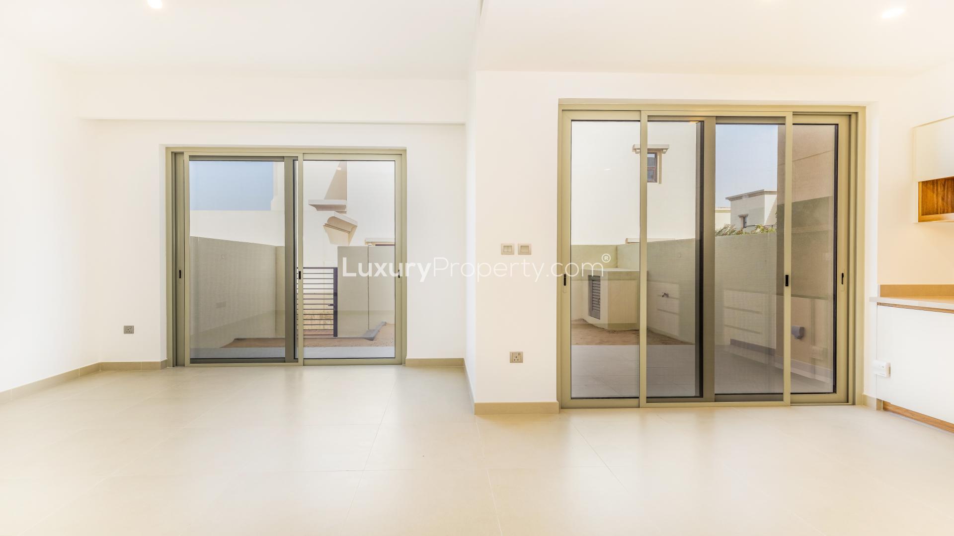 Modern kitchen and living area in Camelia townhouse, Arabian Ranches II, for sale