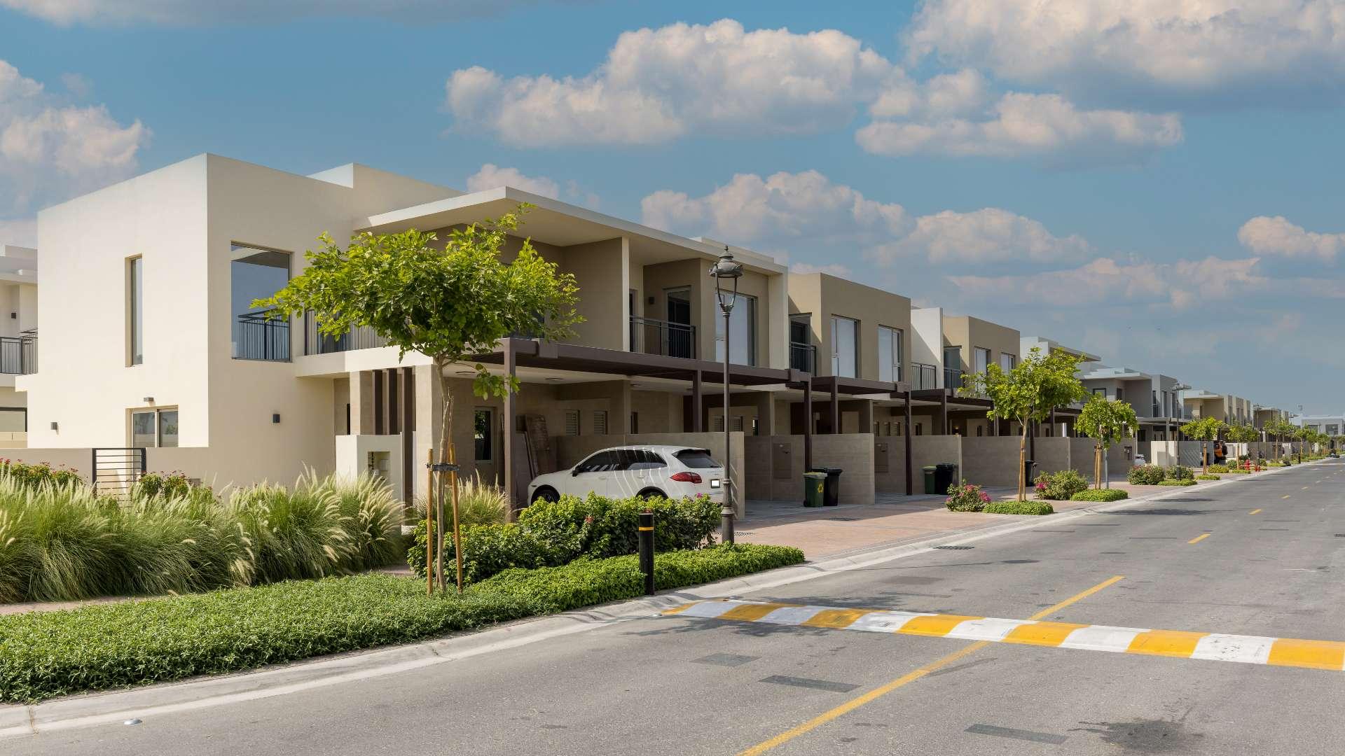 Brand new kitchen in Camelia townhouse, Arabian Ranches 2, featuring modern cabinetry and patio access