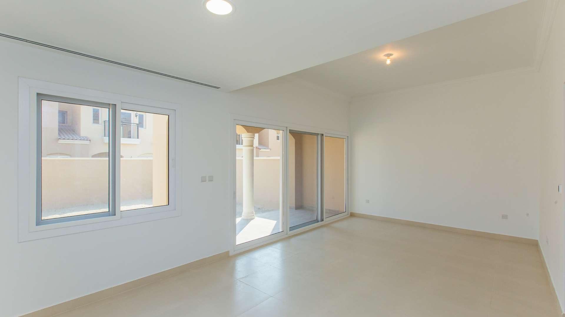 Spacious living room with large windows in Casa Dora townhouse, Serena community for sale