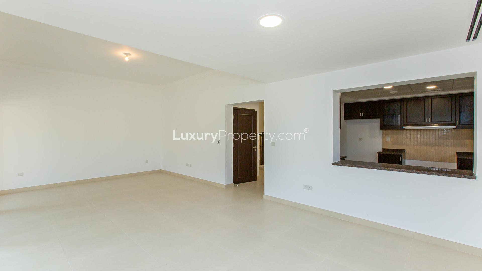 Bright living room in Casa Dora townhouse, Serena community, with large windows and tiled floor