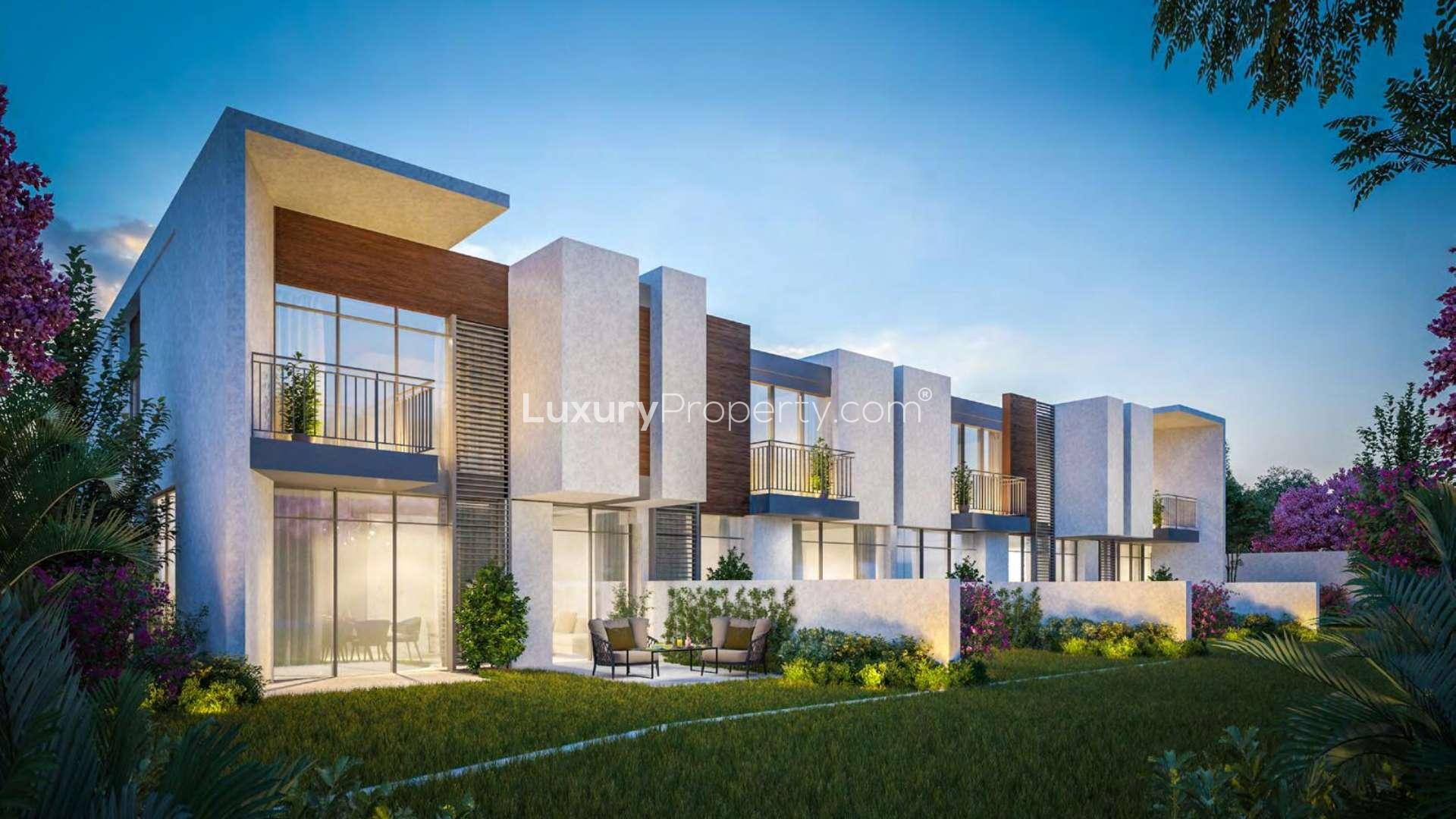 Modern kitchen with breakfast bar in Cherrywoods townhouse, Dubailand, overlooking landscaped garden