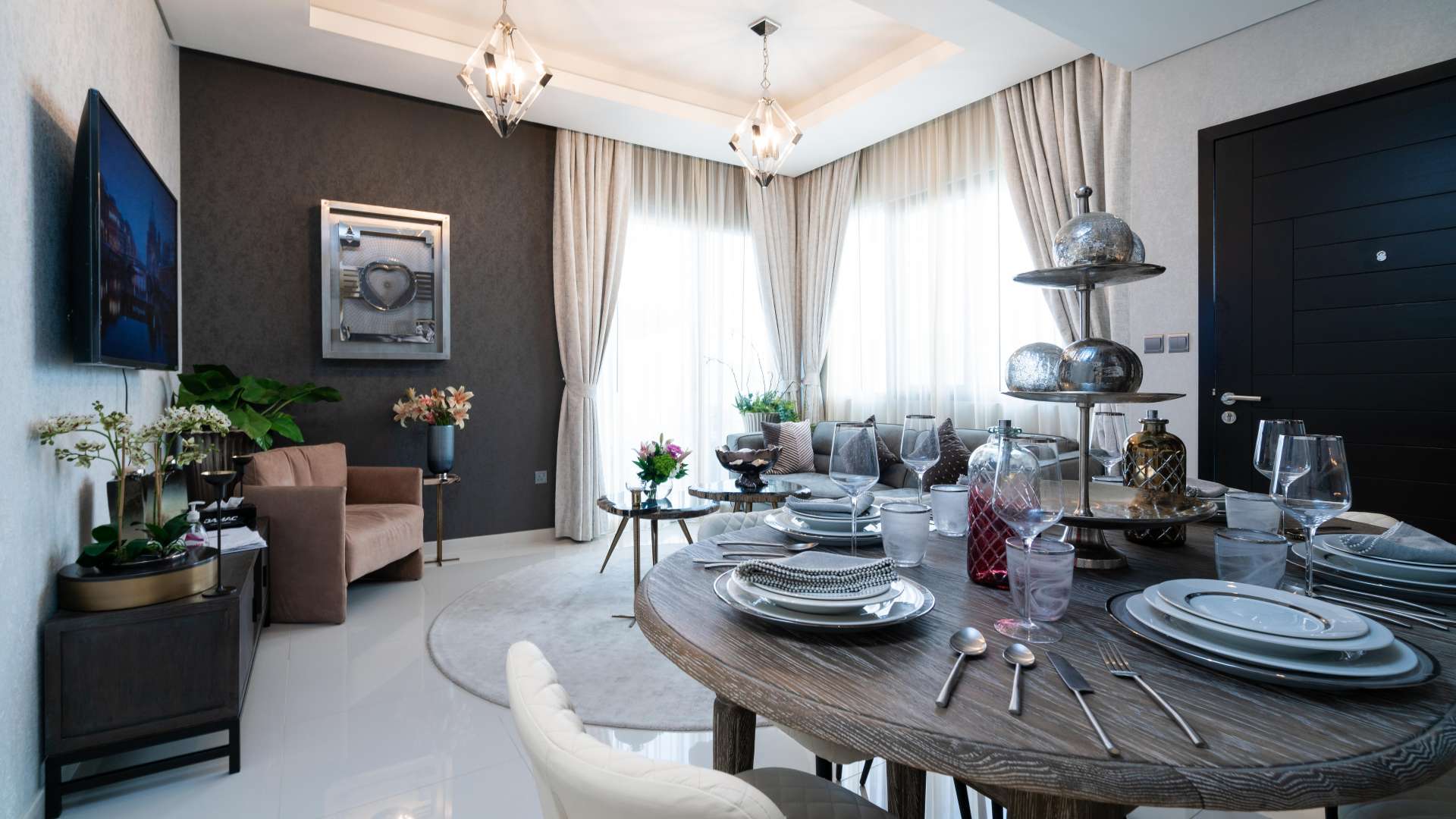 Stylish patio area with umbrella, plants, and seating in Damac Hills 2 townhouse