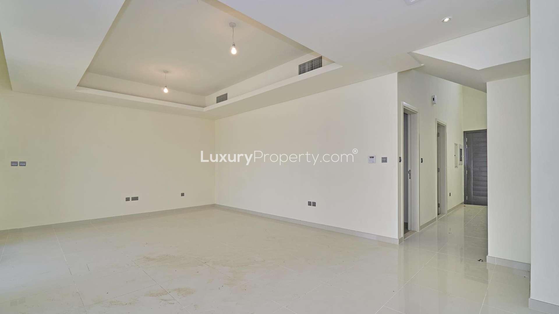 Empty living room in a stylish three-bedroom townhouse, Claret, Damac Hills 2, for sale
