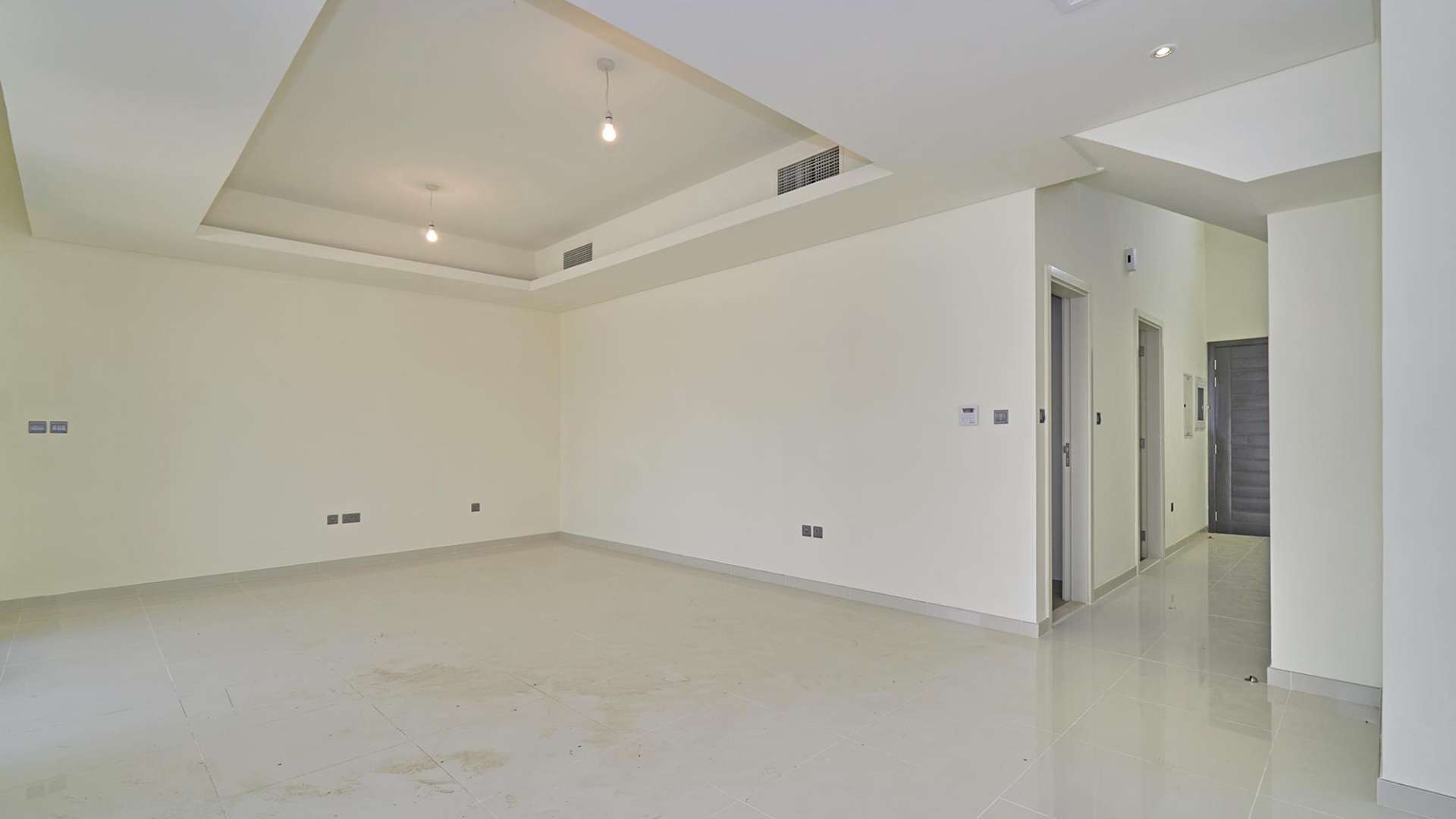 Empty living room in a stylish three-bedroom townhouse, Claret, Damac Hills 2, for sale