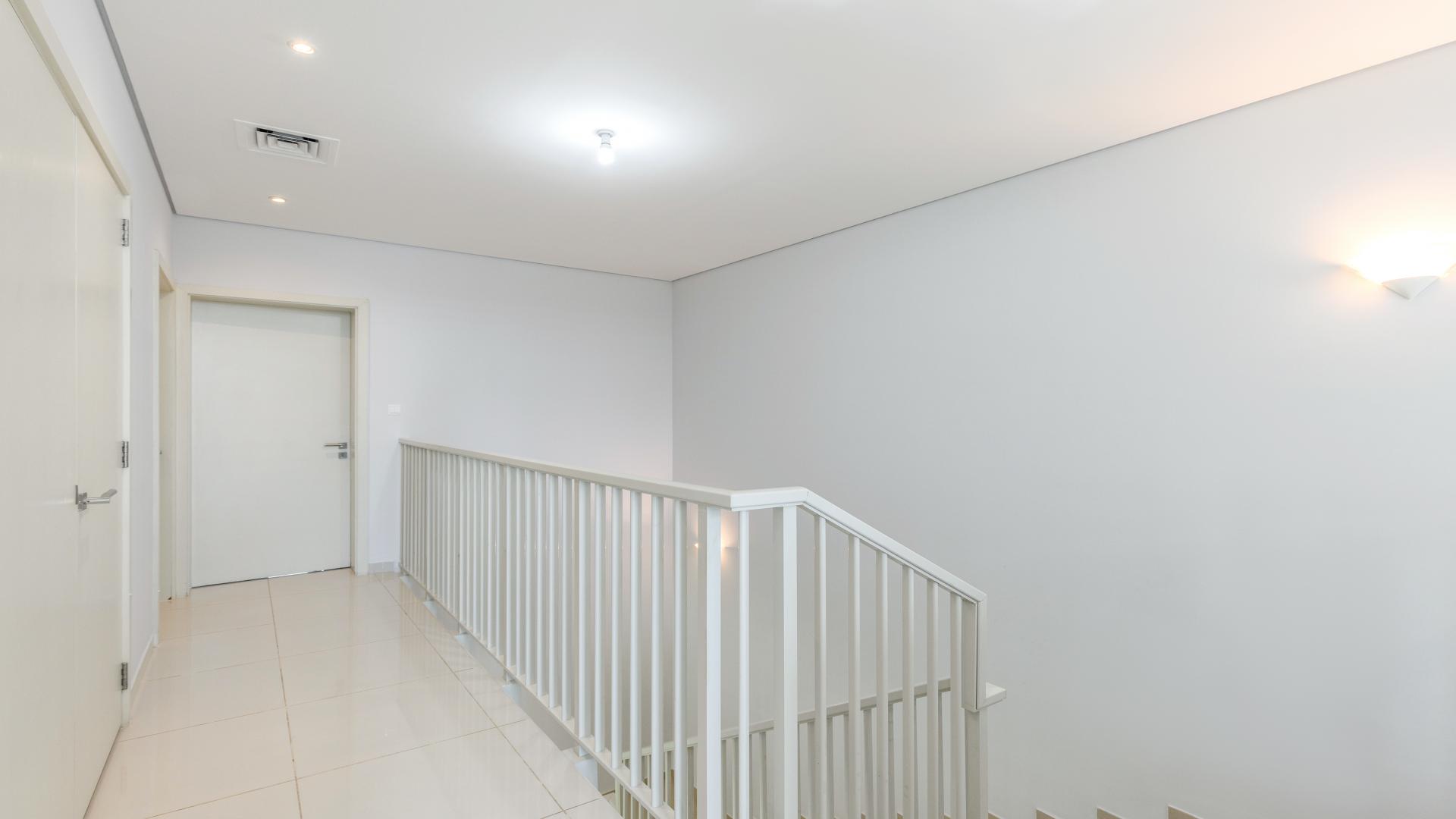 Modern dining and living area in Topanga townhouse, Damac Hills, with garden view