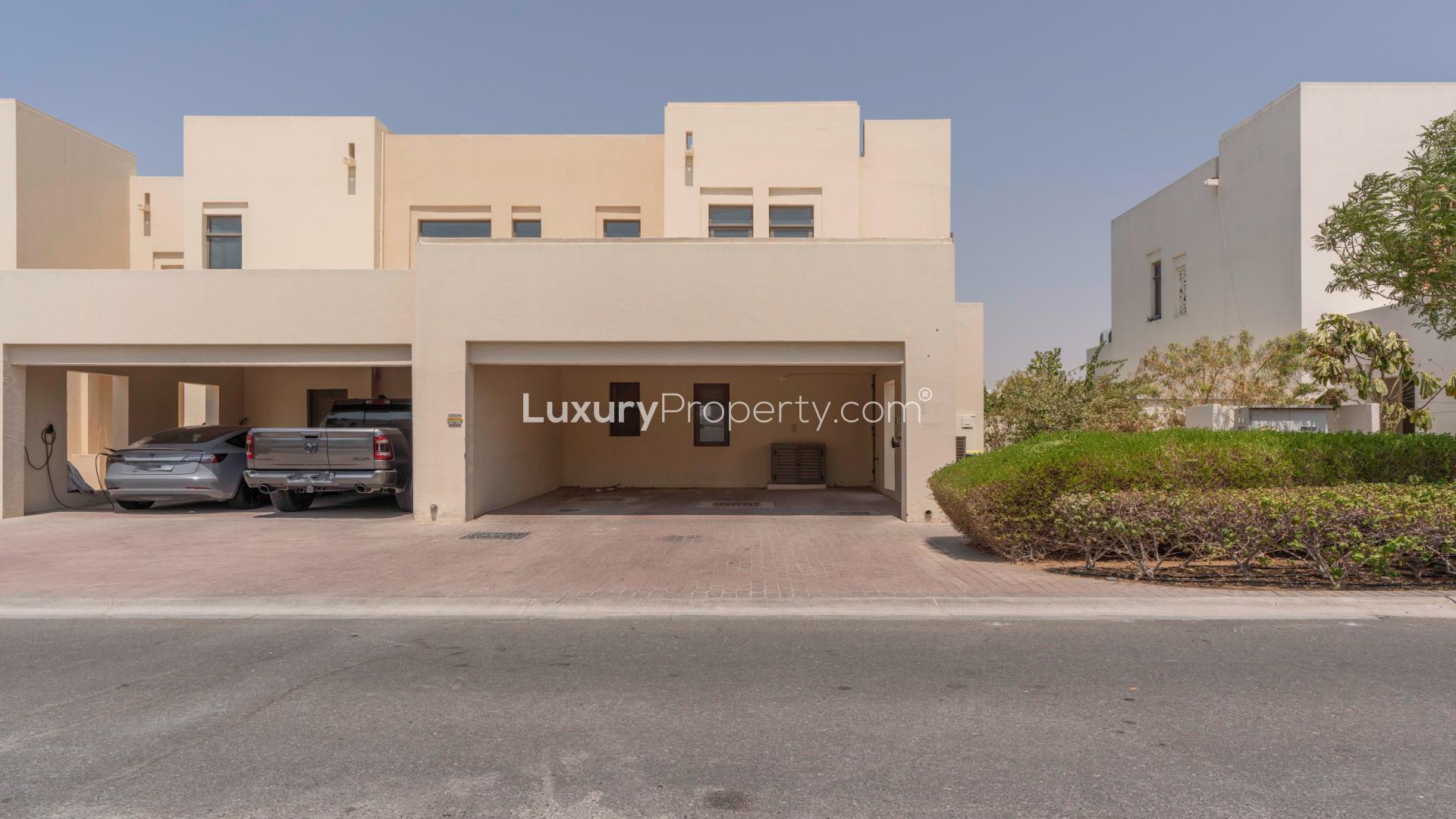 Single-row Type H townhouse exterior in Mira Oasis, Reem community, featuring garage and driveway
