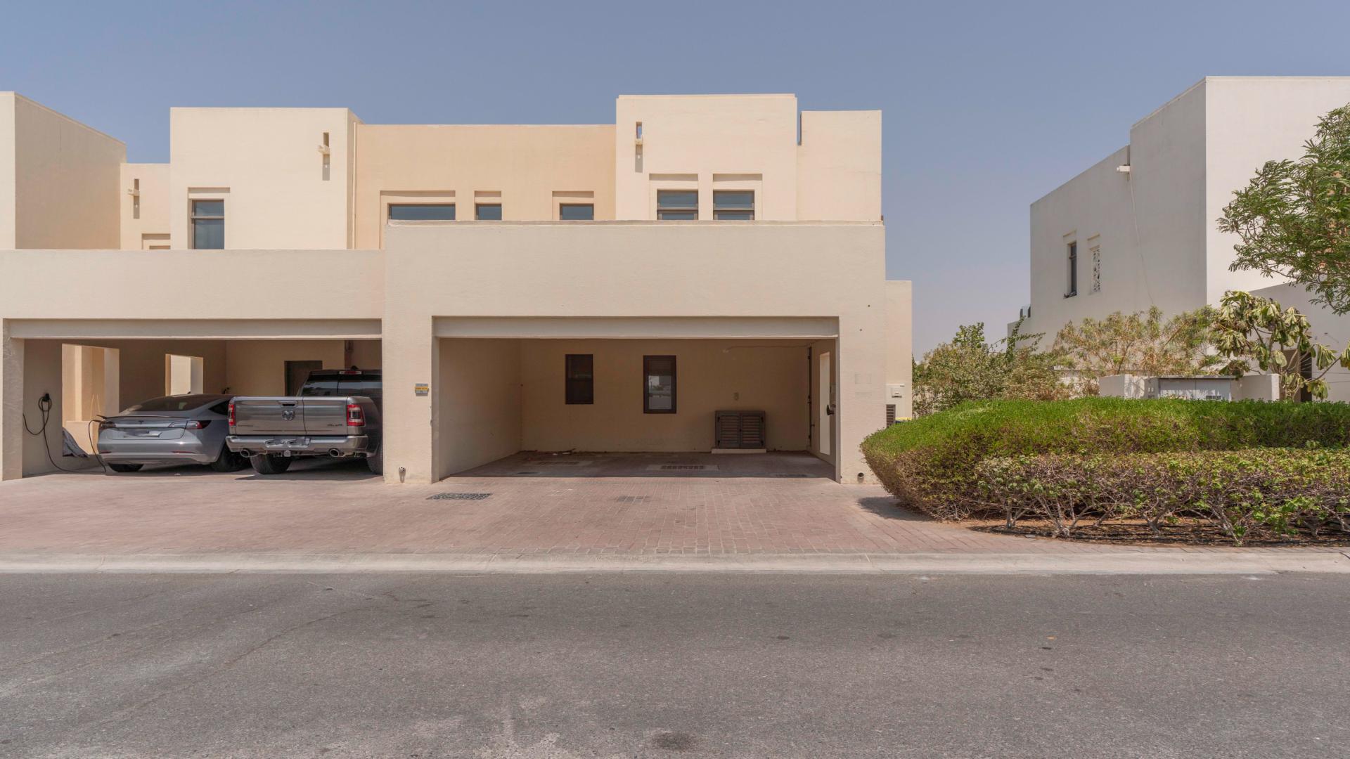 Single-row Type H townhouse exterior in Mira Oasis, Reem community, featuring garage and driveway