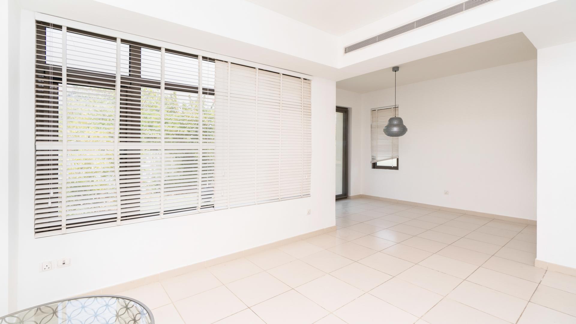 "Modern 3-bedroom townhouse for sale in Mira Oasis, Reem community, single-row Type H.",Bright living area in Mira Oasis townhouse with large windows and modern lighting fixtures