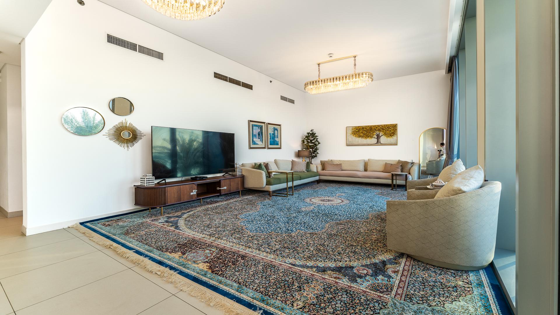 Sunny balcony with glass railing and palm tree views at Dubai Creek Harbour townhouse