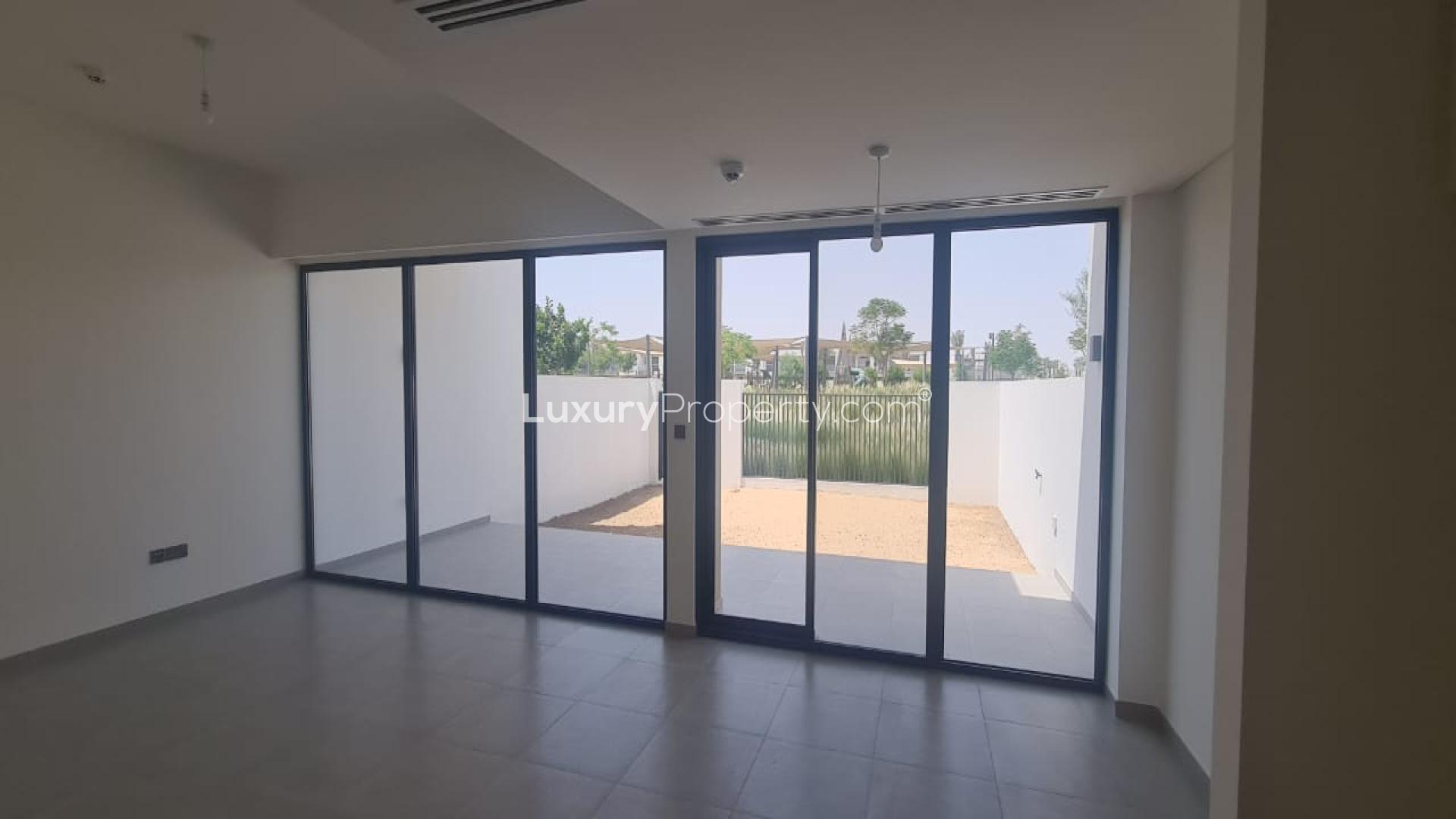 Spacious living room with large windows in Eden The Valley townhouse for sale