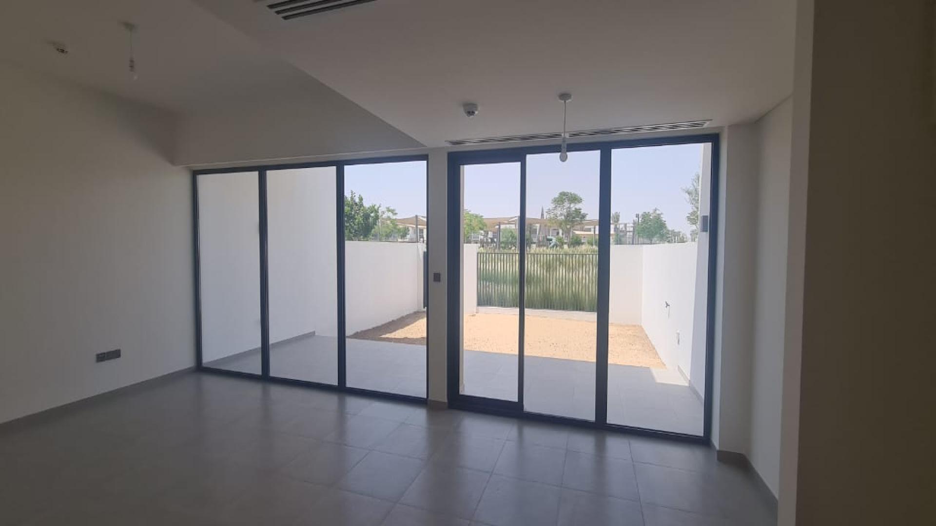 Spacious living room with large windows in Eden The Valley townhouse for sale