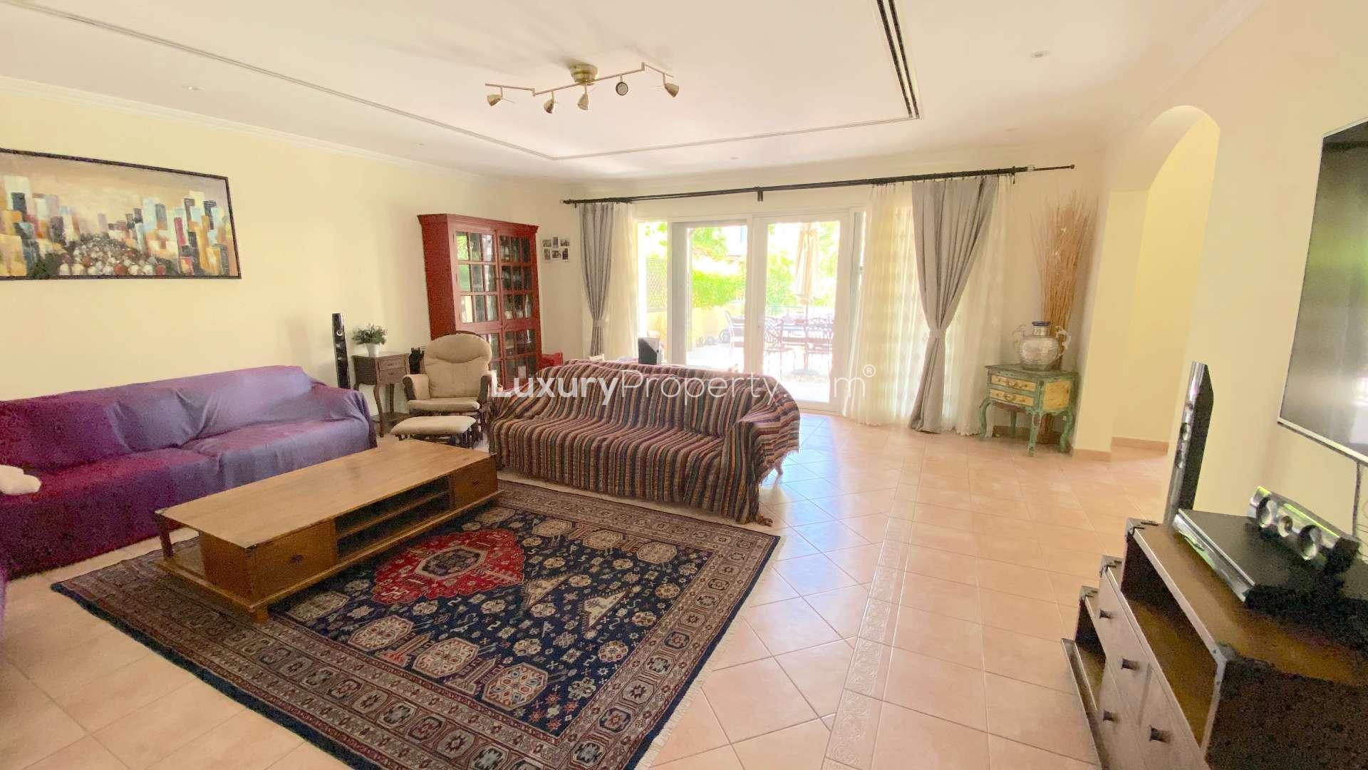 Upgraded 3-bedroom townhouse exterior with lush garden in Green Community East for sale