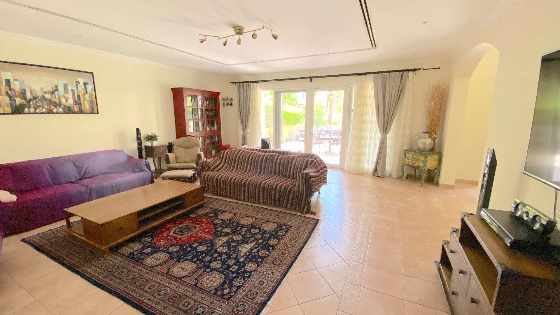 Upgraded 3-bedroom townhouse exterior with lush garden in Green Community East for sale