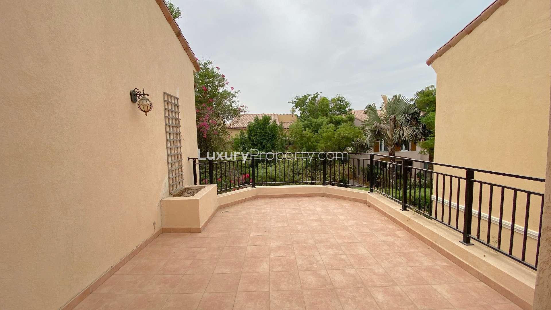 Garden view of 3-bedroom townhouse in Green Community East, featuring lush greenery and flowers