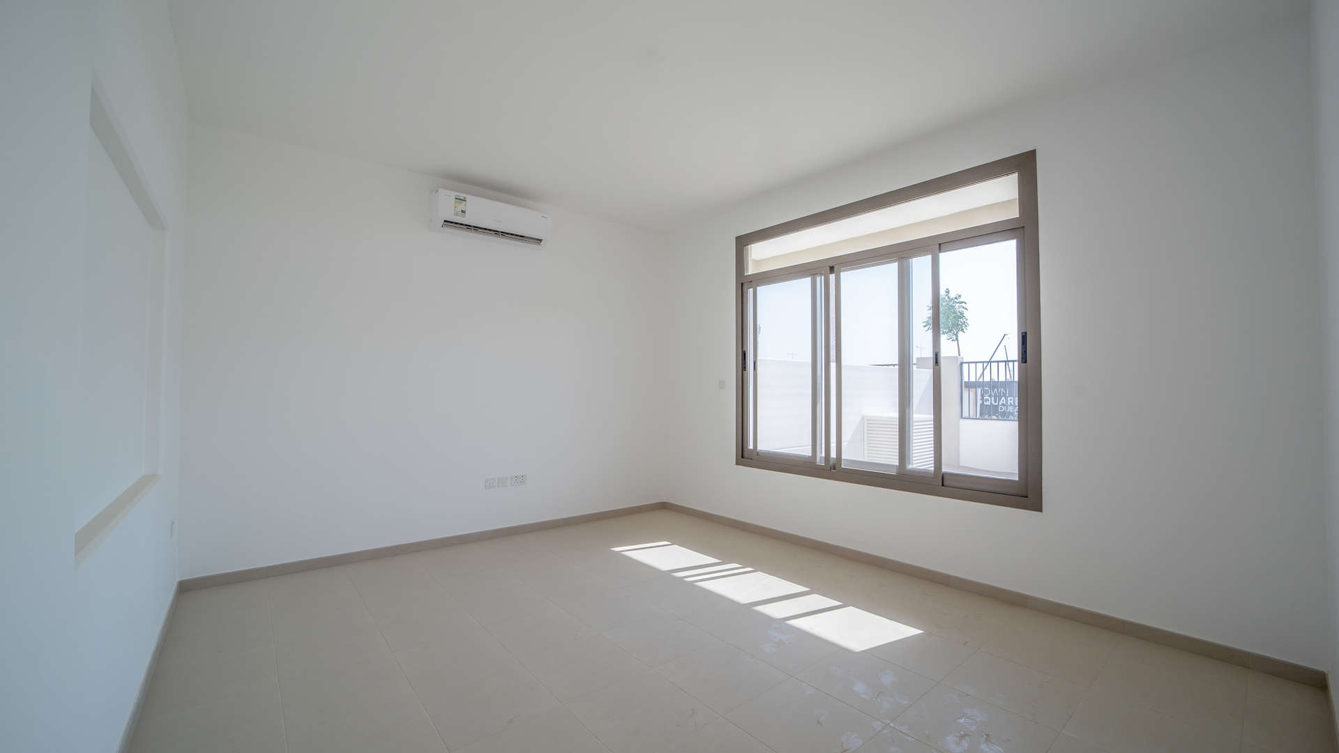 "Bright bedroom with large window in Hayat Townhouse, Town Square, Dubai, for sale.",Bright interior of 3-bedroom townhouse in Hayat, Town Square, Dubai for sale