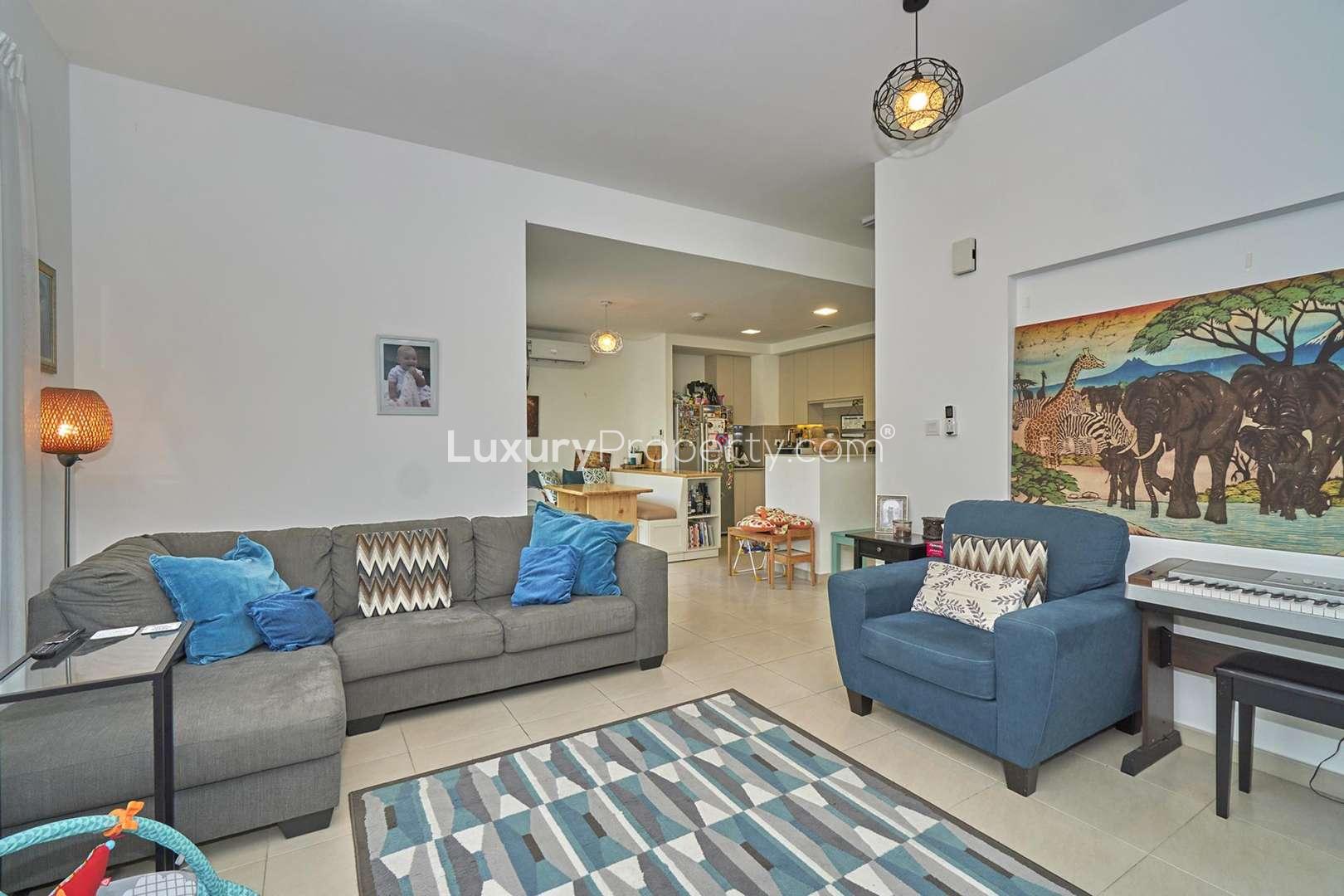 Living room of 3-bedroom townhouse in Hayat, Town Square, Dubai, with cozy furnishings