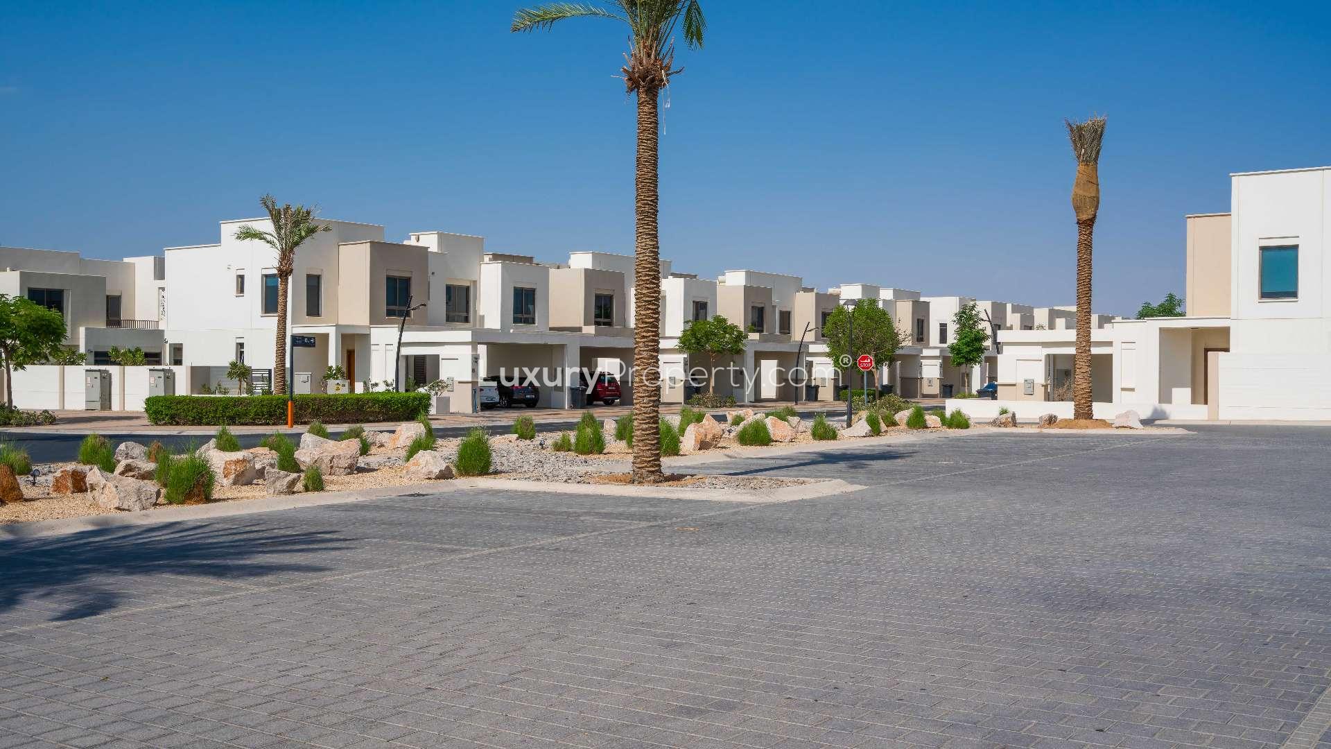 Modern living room in Hayat Town Square townhouse with large TV and stylish seating area