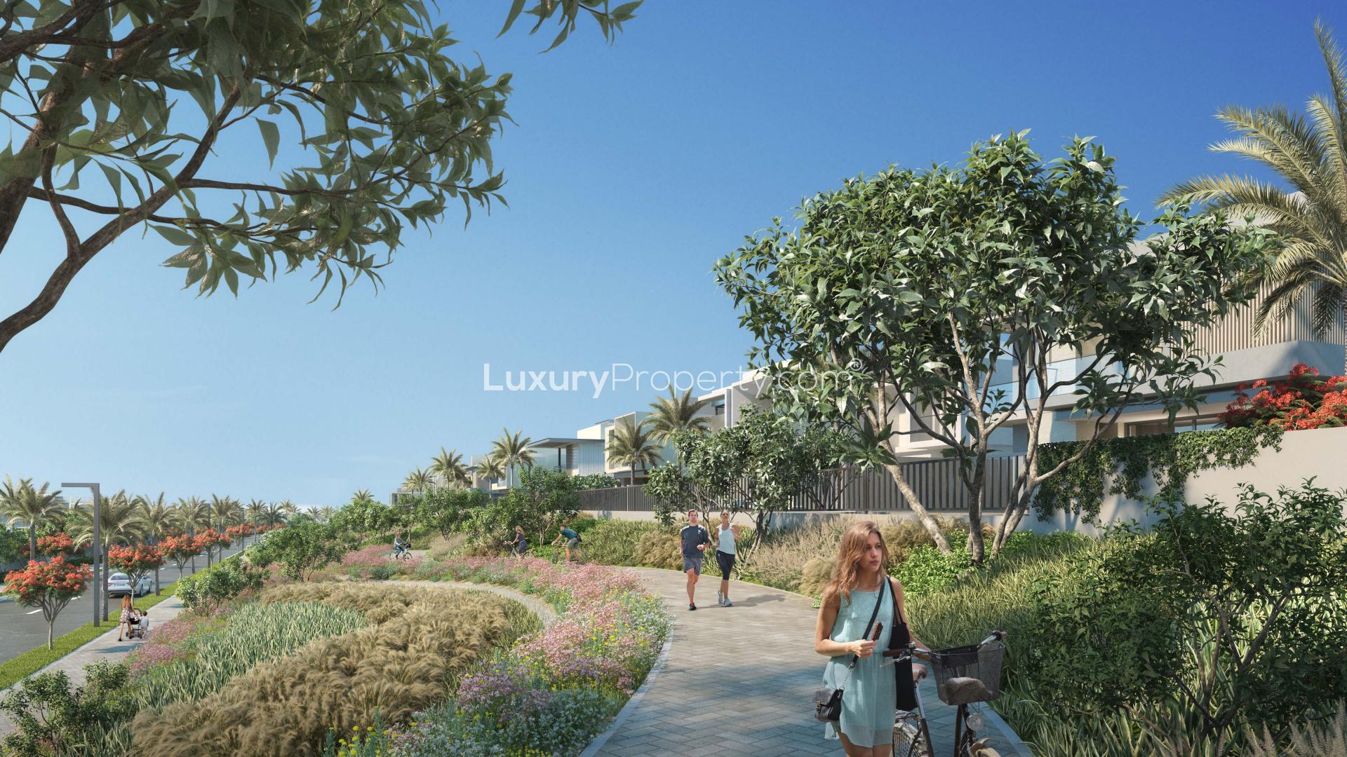 N/A,Modern townhouse exterior with lush landscaping in Jebel Ali Village, Dubai