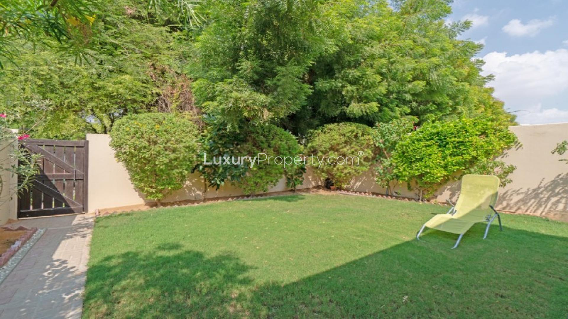 Open-plan living room in Al Reem townhouse, featuring modern decor and large windows