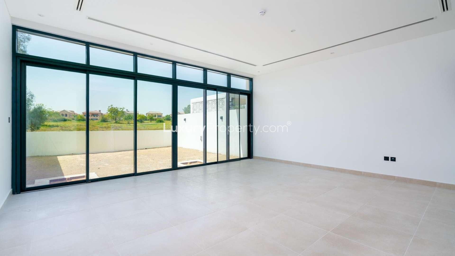 Contemporary townhouse interior with large windows overlooking Jumeirah Golf Estates scenery