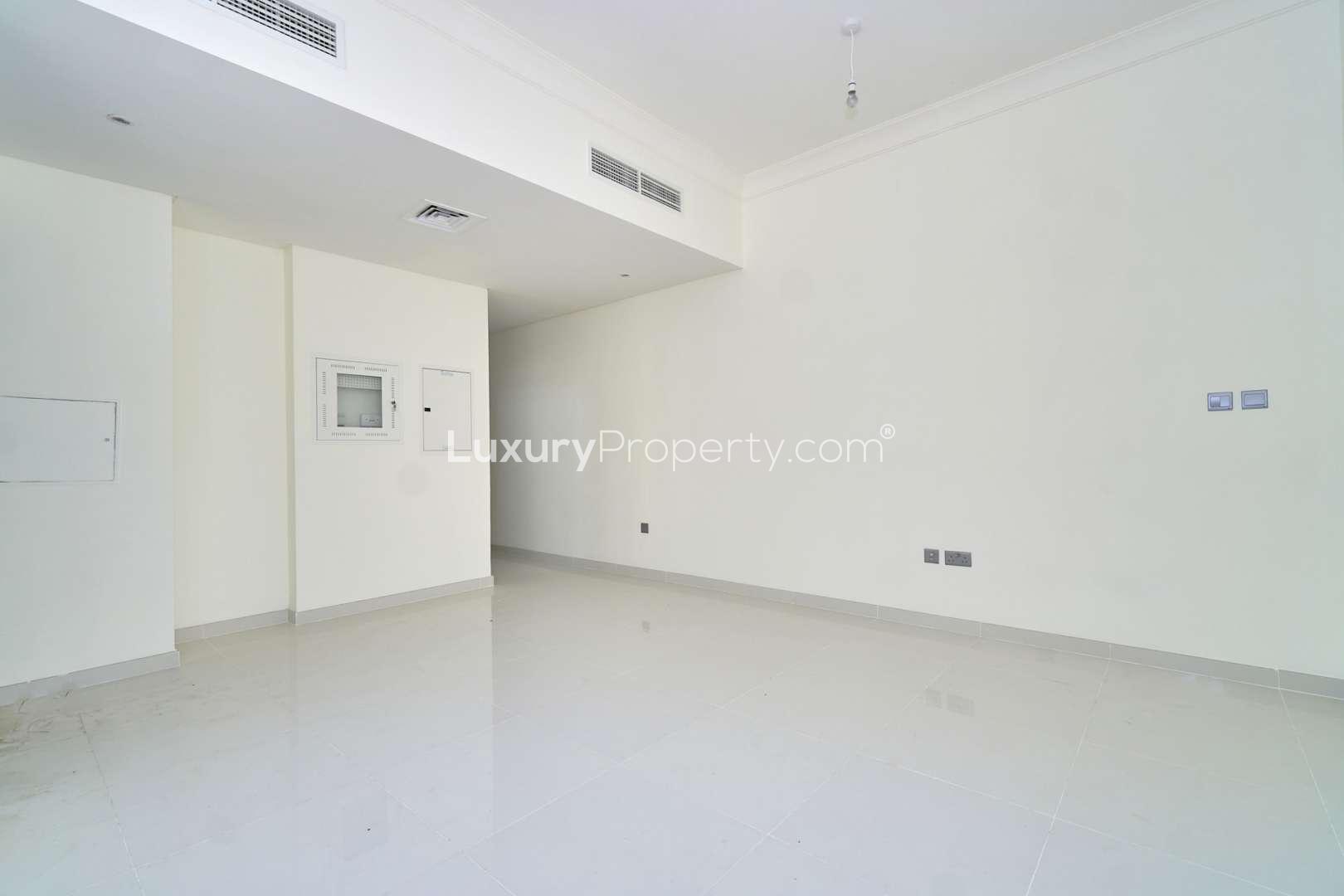 Bright living room with large window in Juniper townhouse, Damac Hills 2, Akoya community