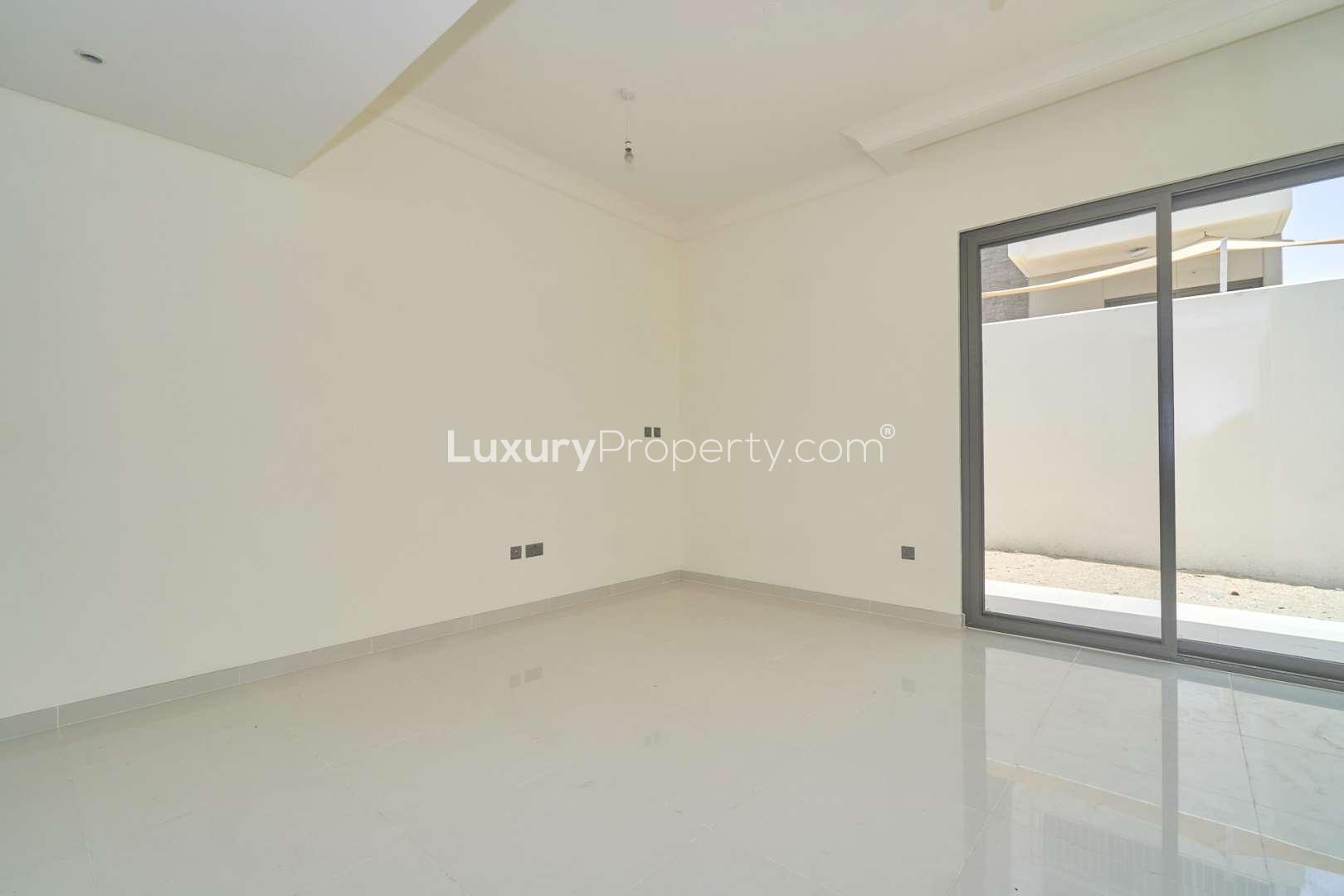 Three-bedroom townhouse interior, spacious living area with large windows in Juniper, Damac Hills 2