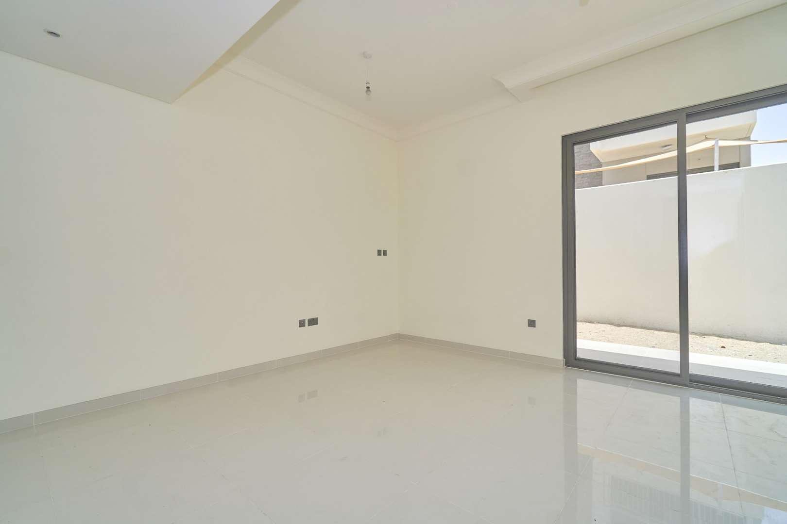 Three-bedroom townhouse interior, spacious living area with large windows in Juniper, Damac Hills 2
