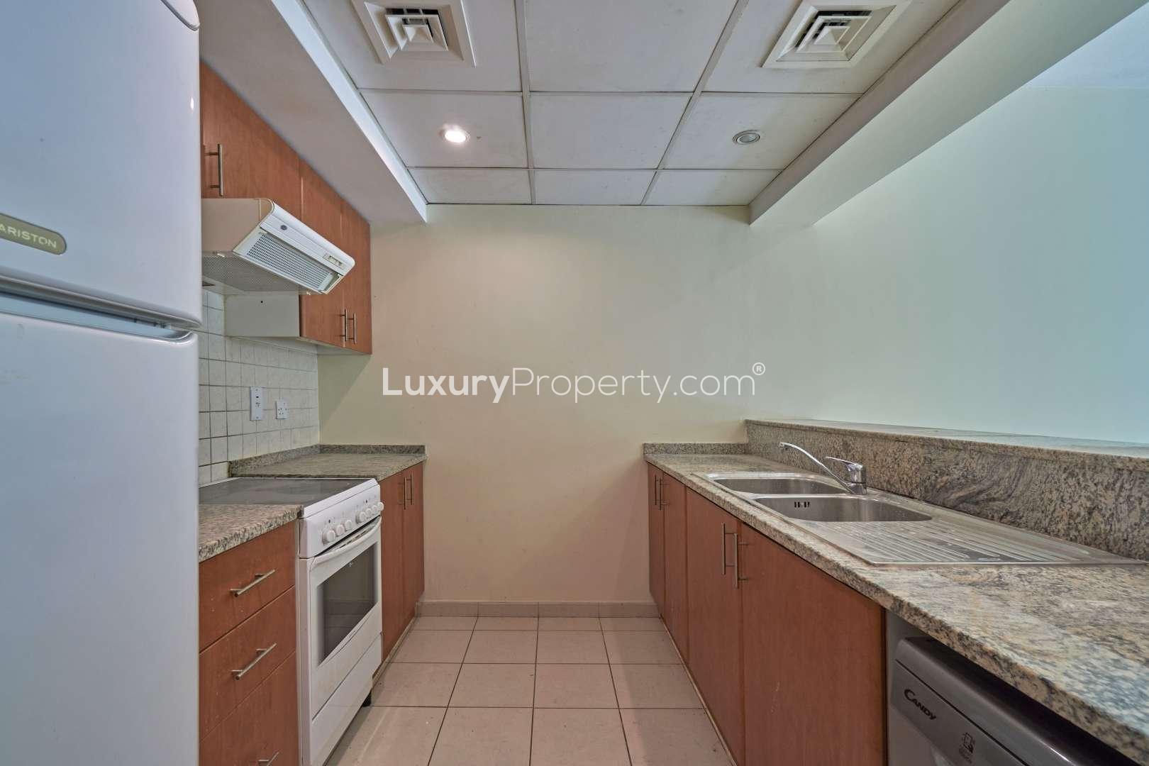 Empty bedroom in Maple townhouse, Dubai Hills Estate, featuring built-in closets and tiled floors
