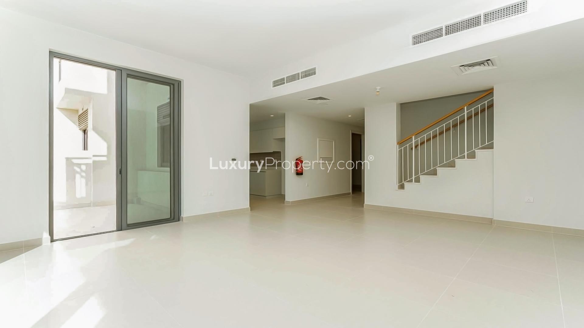 Modern 3-bedroom villa exterior in Maple, Dubai Hills Estate, featuring balcony and large windows