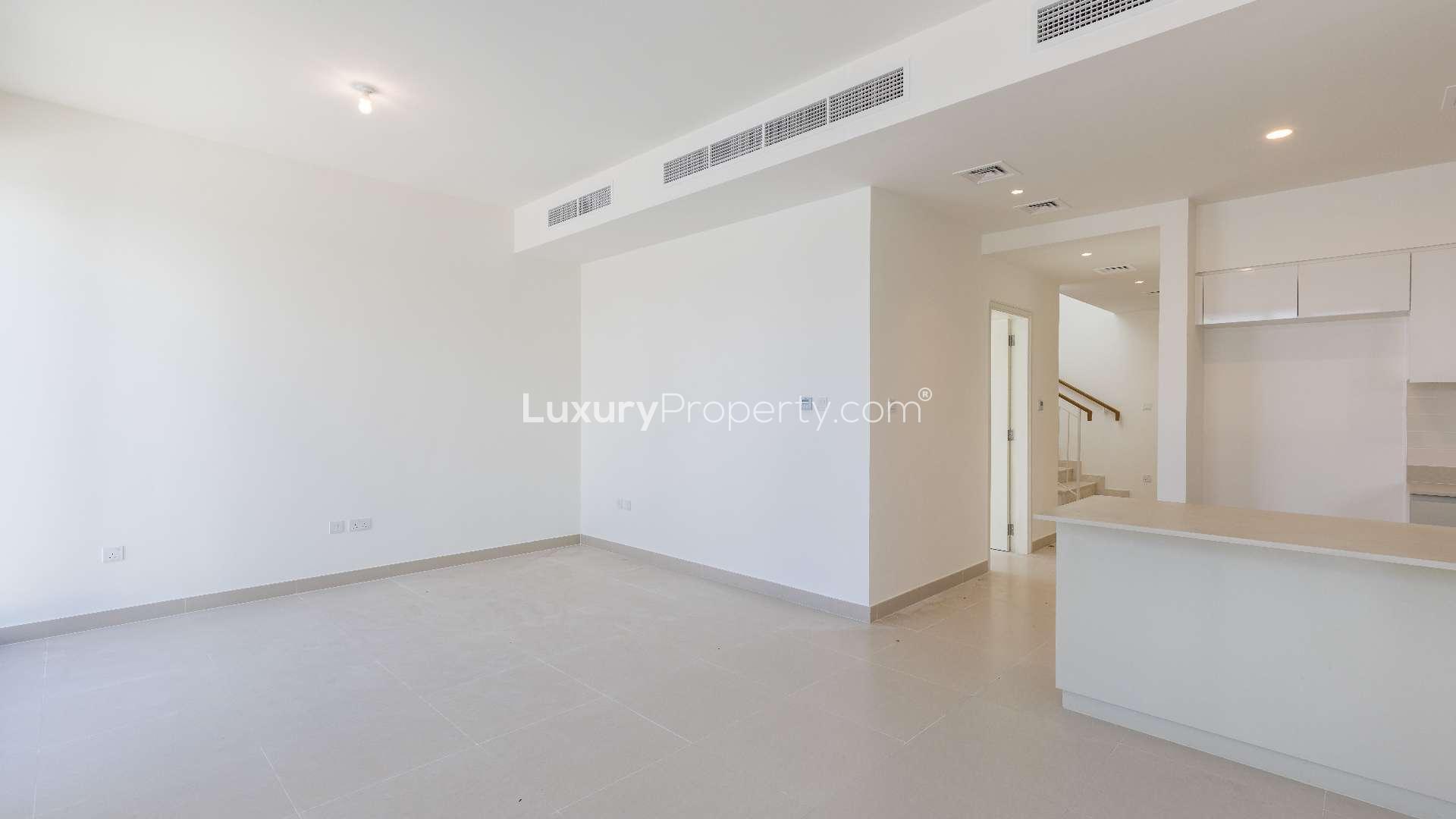 Alt text: "View from balcony of 3-bedroom villa in Maple 3, Dubai Hills Estate for rent.",Elegant open-plan living area in 3-bedroom villa, Maple 3, Dubai Hills Estate