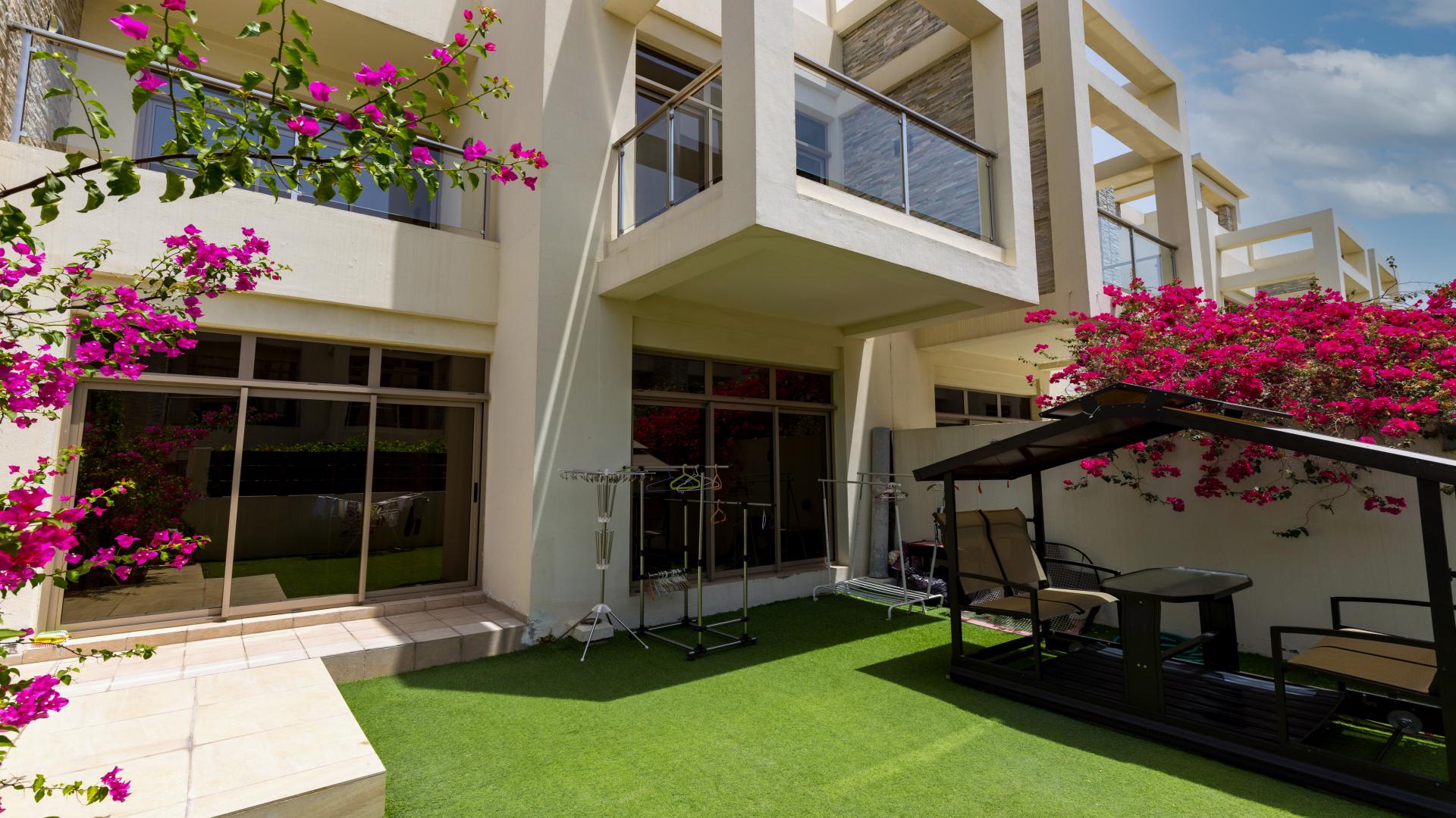 Modern living room in Meydan Polo Townhouse with elegant decor and ample natural light