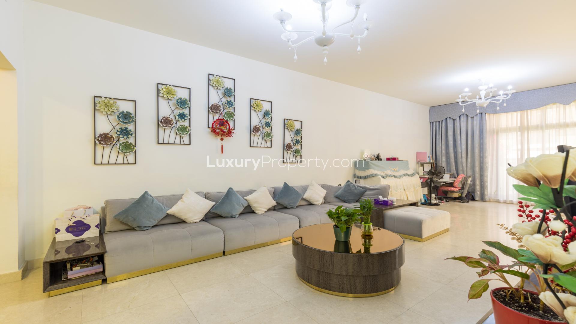 Exterior of 3-bedroom townhouse in Meydan, featuring modern design and vibrant bougainvillea
