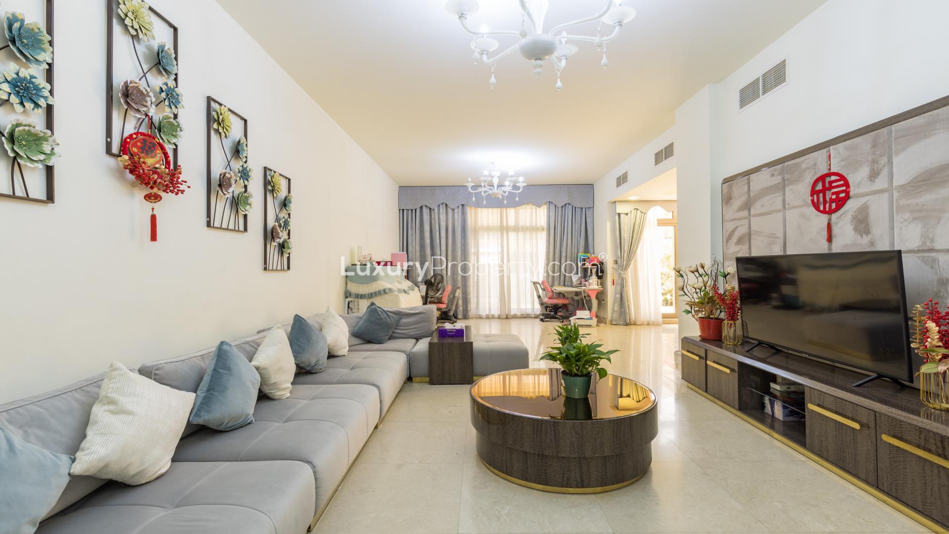 Exterior view of Meydan townhouse garden with seating area and vibrant flowers