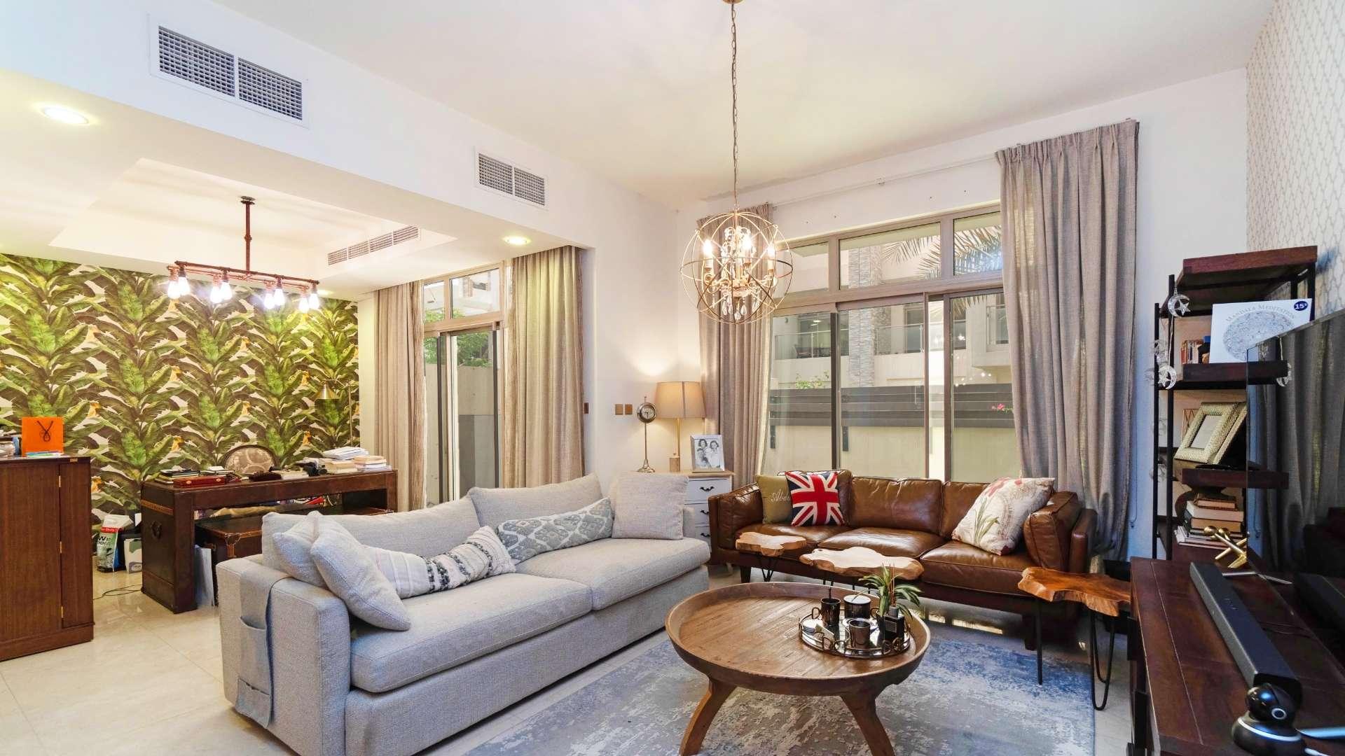 Living room in spacious Meydan Polo townhouse with modern decor and natural light